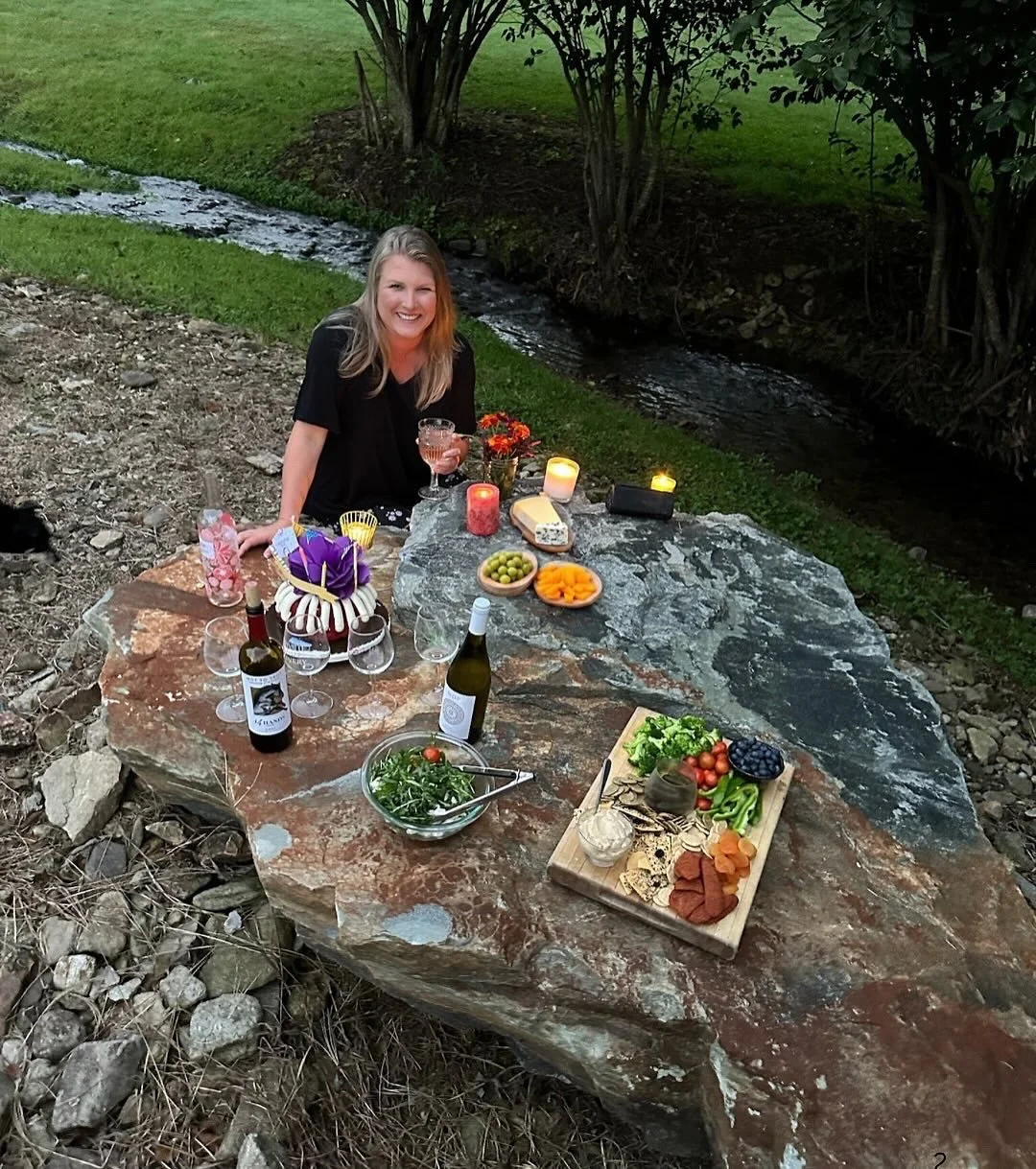 Who needs a table when nature provides the most stunning setting&mdash;a rock by the creek. 🌿✨

Western North Carolina is full of hidden gems&mdash;mountain views, waterfalls, vineyards and those unforgettable moments that make a trip feel like pure