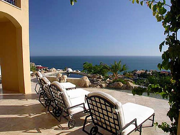 Luxury patio with lounge chairs overlooking ocean view
