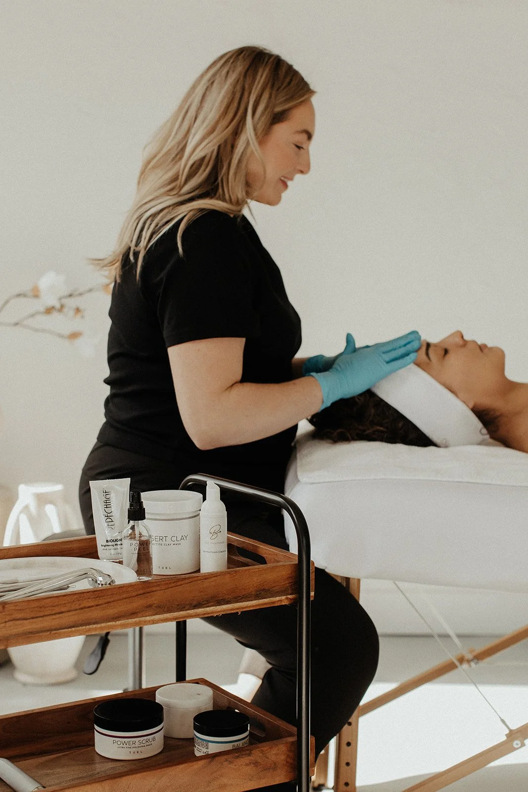 Person with glowing skin receiving a facial treatment