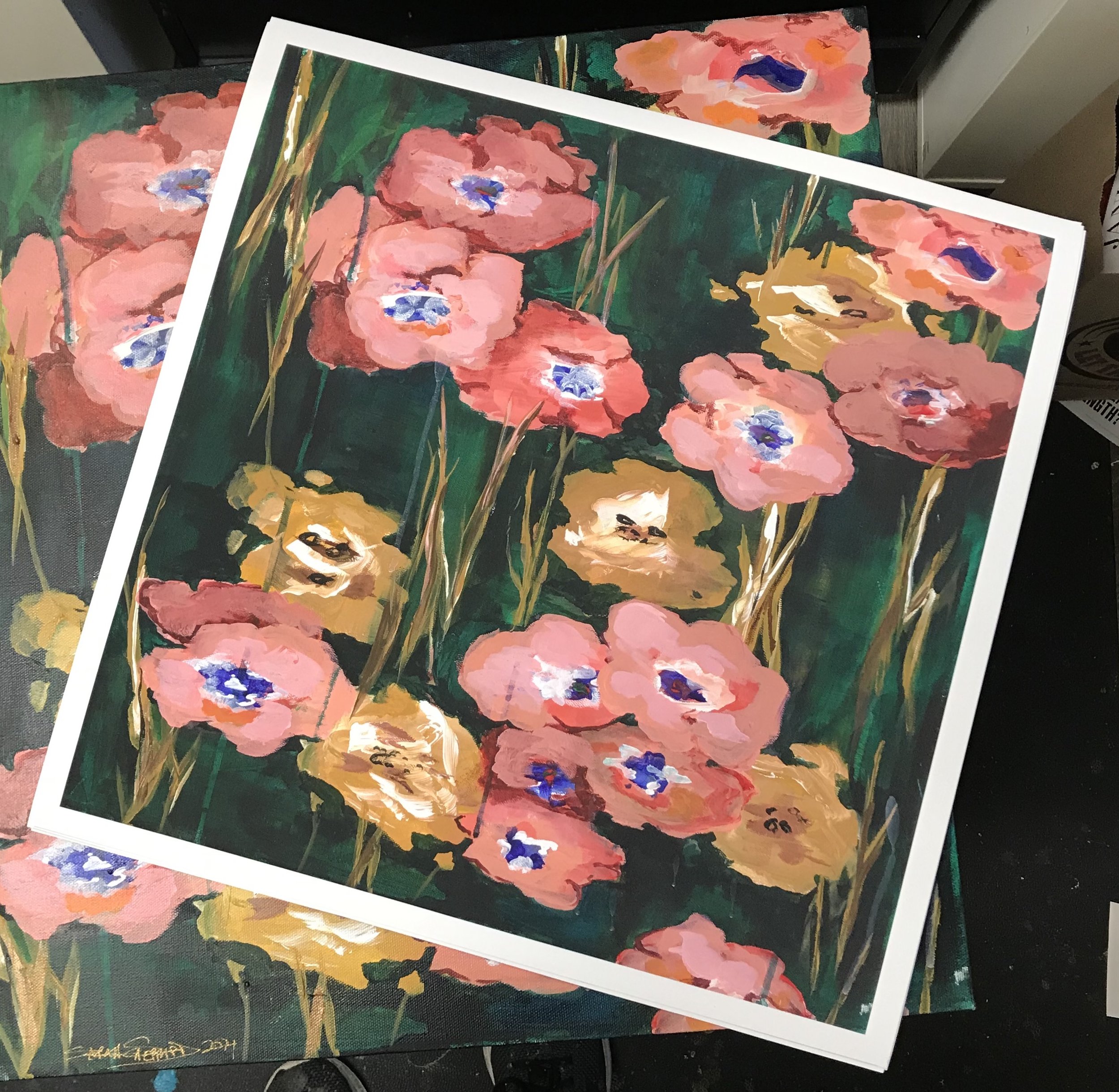 A colorful painting of pink, yellow, and orange flowers with blue centers, set against a dark green background.