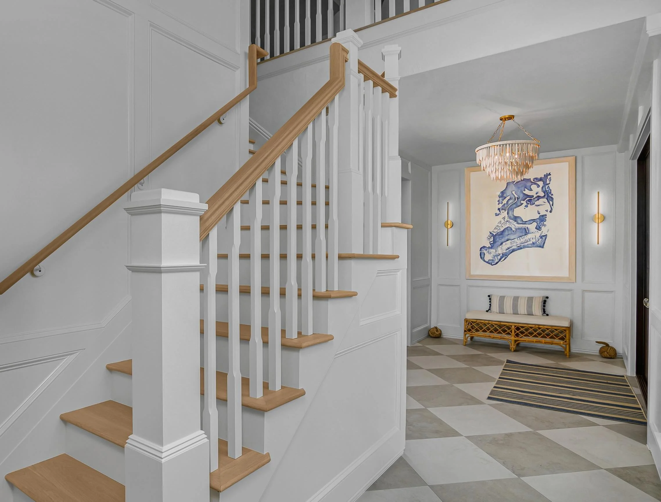 An entryway sets the tone for the entire home. Custom millwork was designed to frame our client&rsquo;s artwork and give the space a more intentional feel from the moment you walk in. It&rsquo;s small architectural details like this that make a space