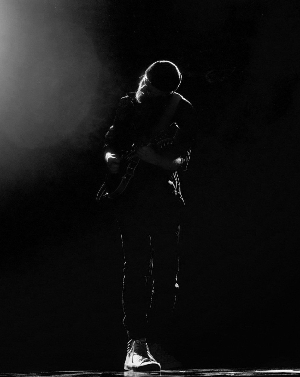 Christian Heidenbauer alone on stage in a spotlight