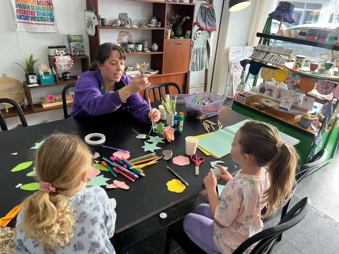 Kids participating in a children's art and craft class with an instructor