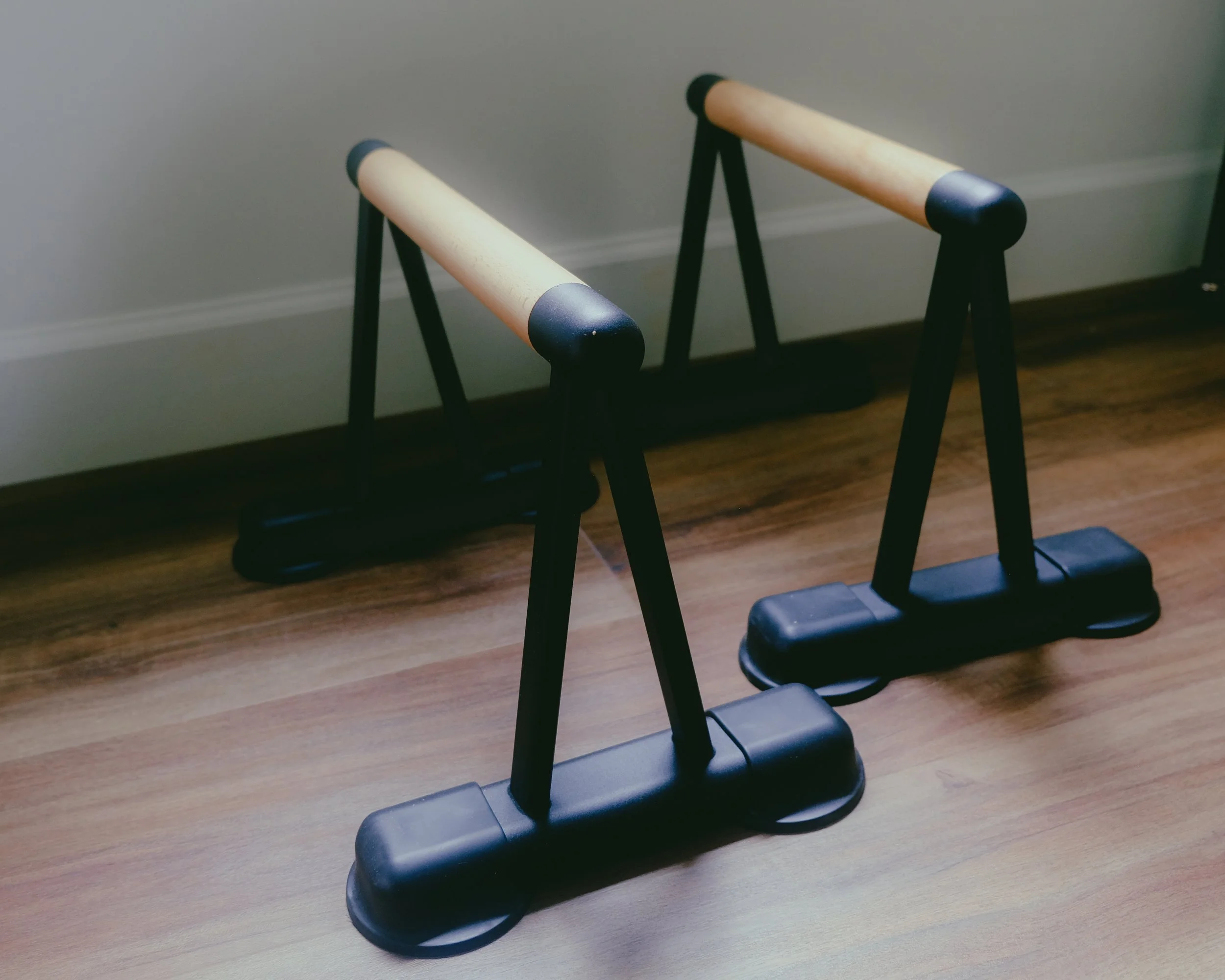 Image of Push-Up Bars, one of many props used at The Pilates Garage, to further develop connection and strength.