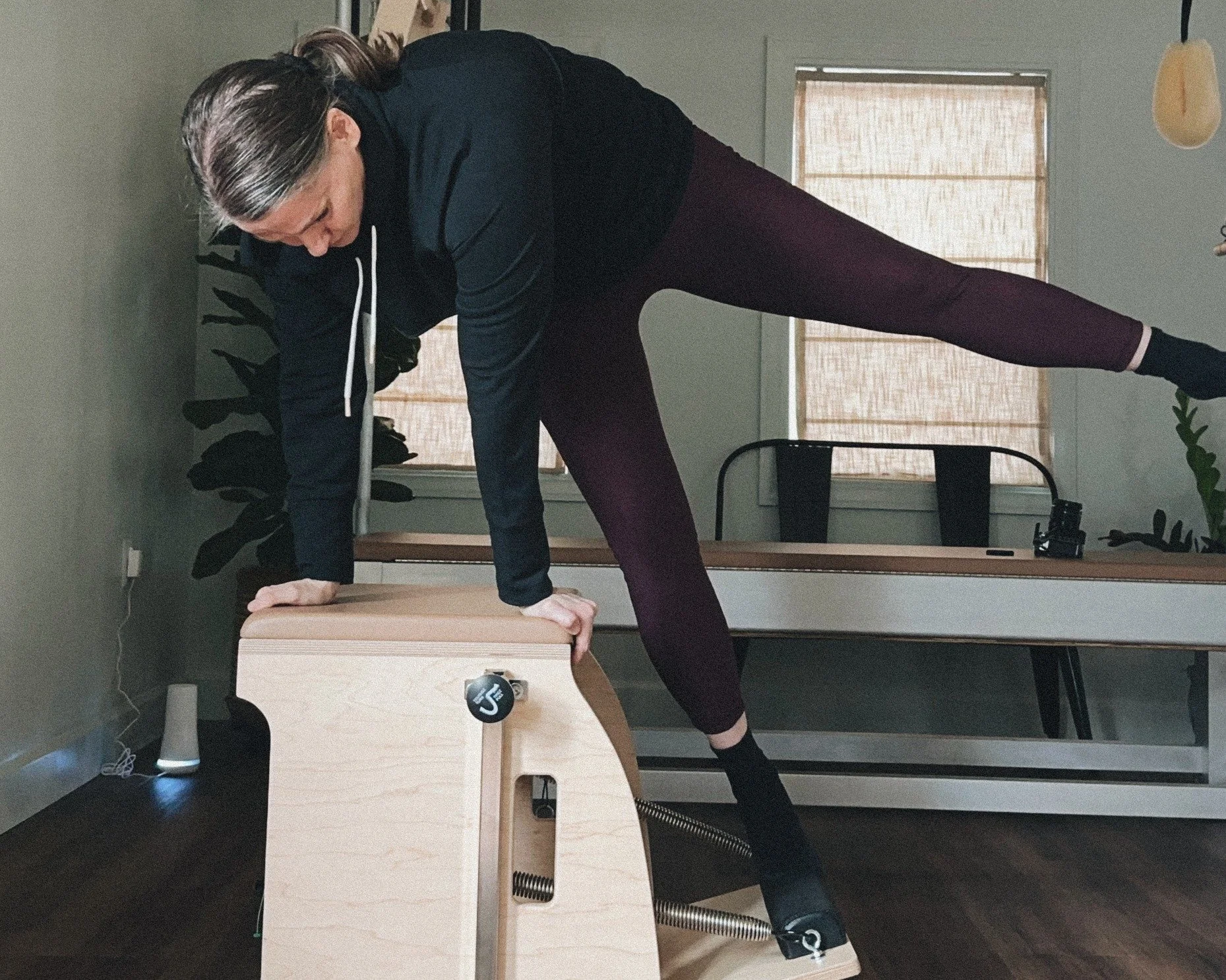 Image of The pilates Garage owner doing Single Leg Side Pull Ups on the Wunda Chair.