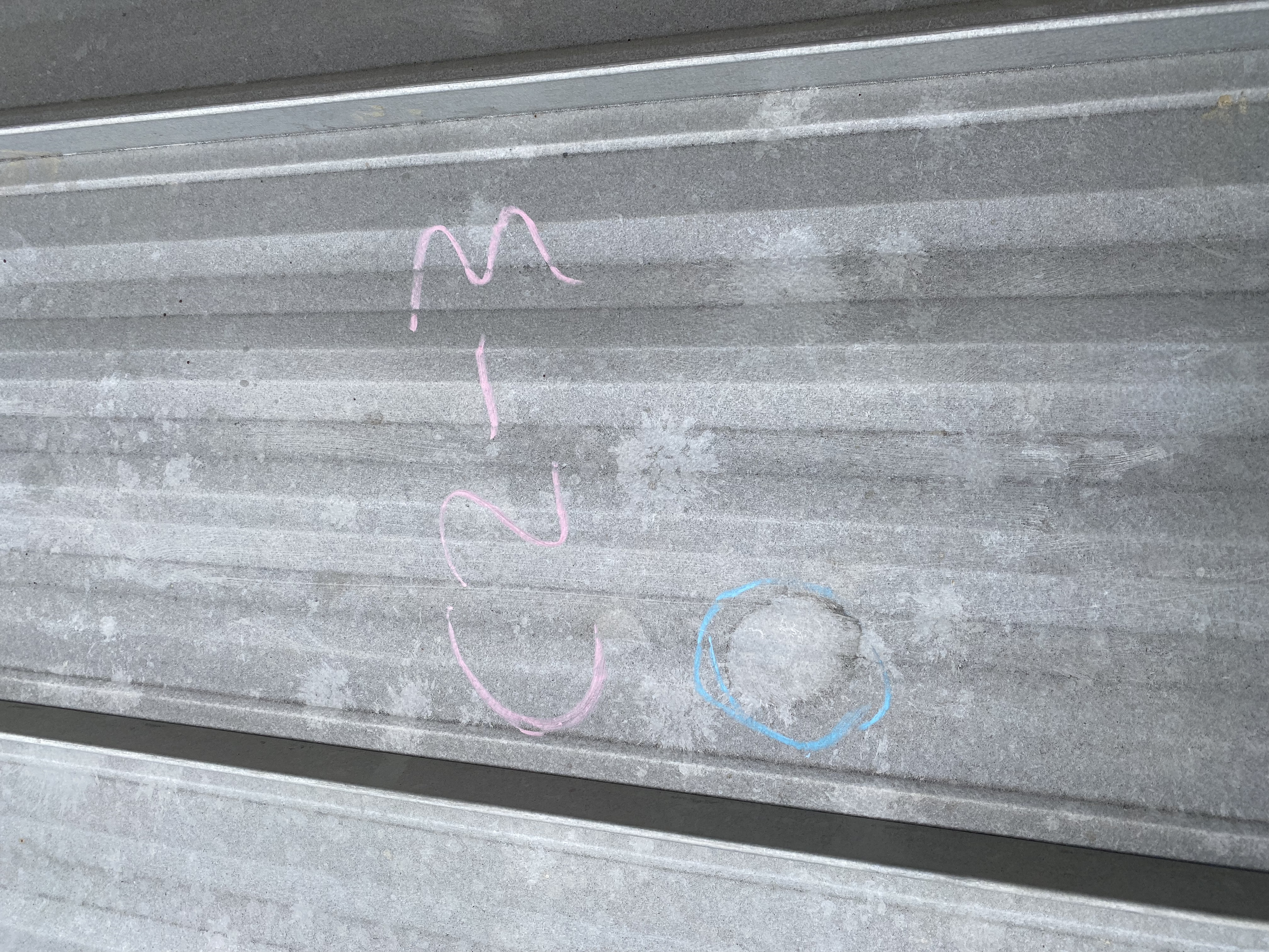 Hail damage and spatter to a metal roof 