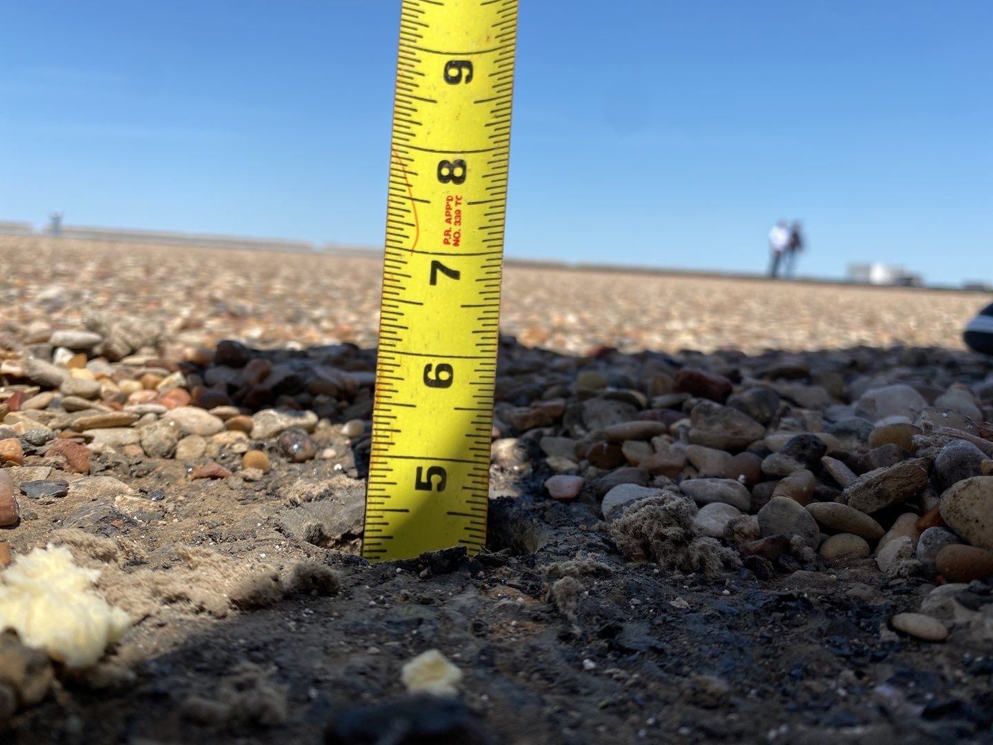 A tape measure used in a core sample from a Built up gravel ballast roof system BUR