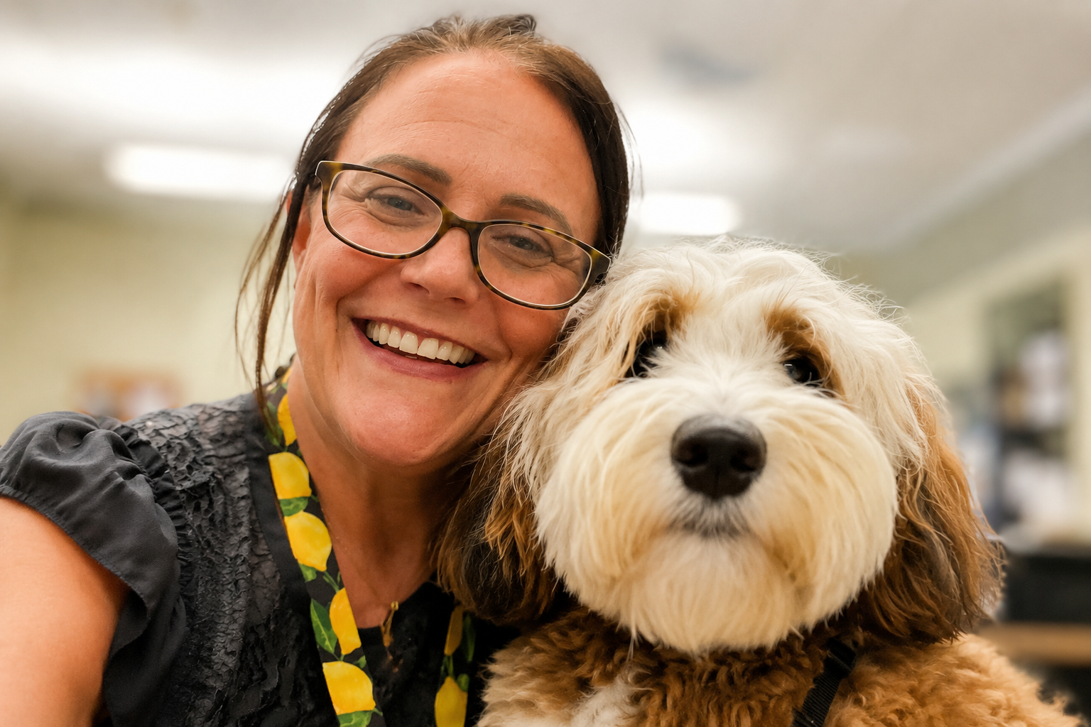 Kristy and Lemon the Labradoodle during a therapy dog visit