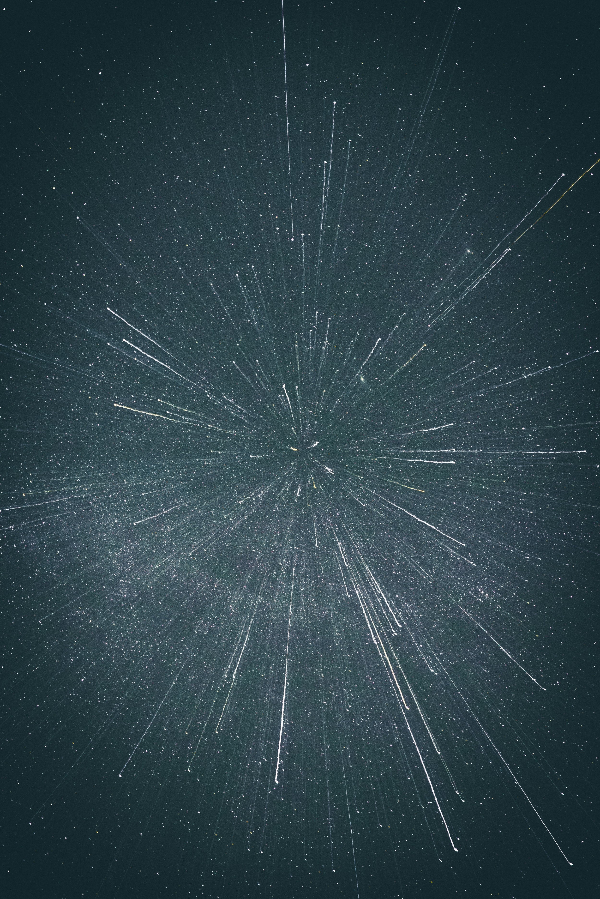 Long exposure photograph of star trails in the night sky, showing streaks of stars radiating from the center.
