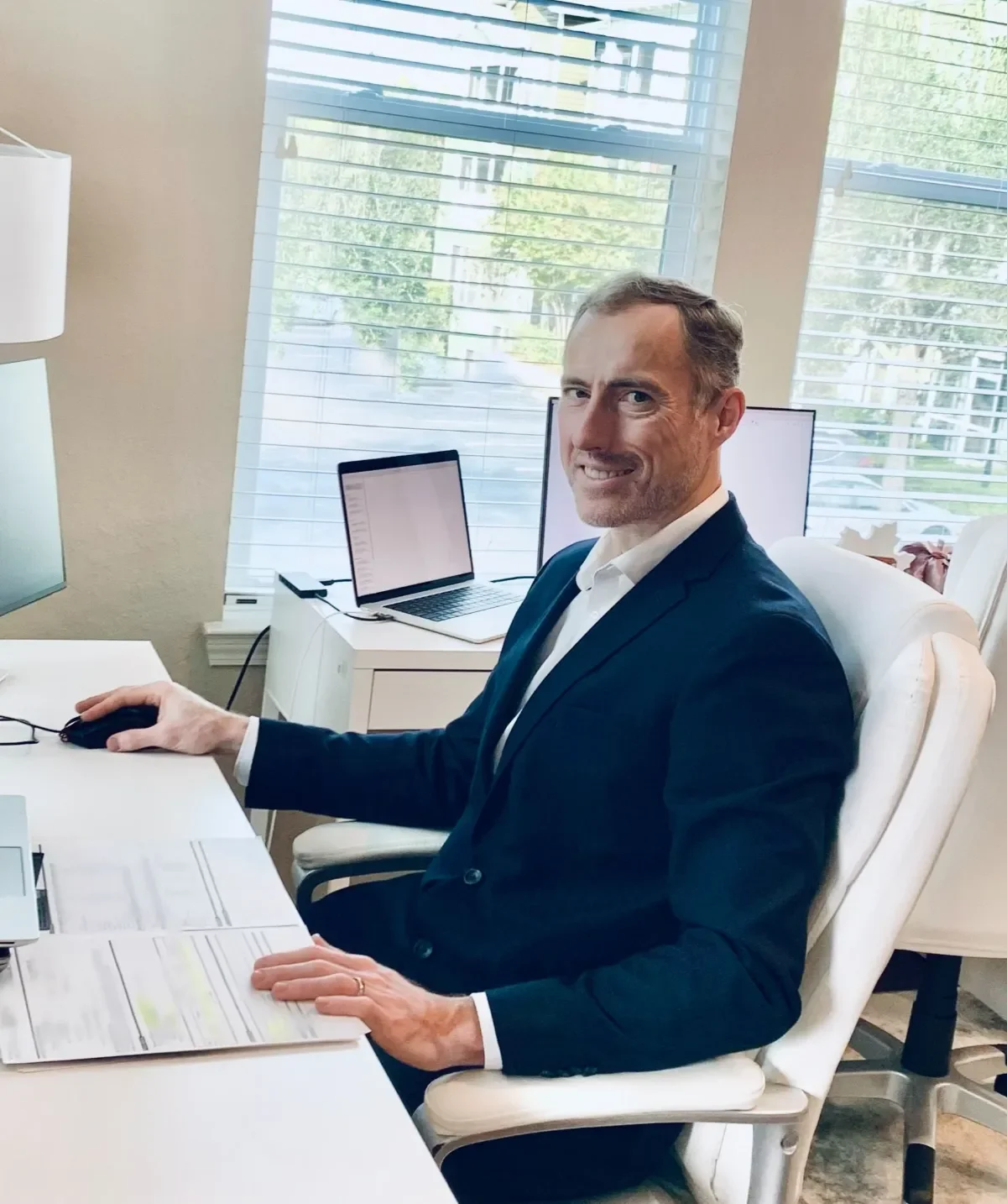 Bookkeeper Vidas working on financial records at a desk
