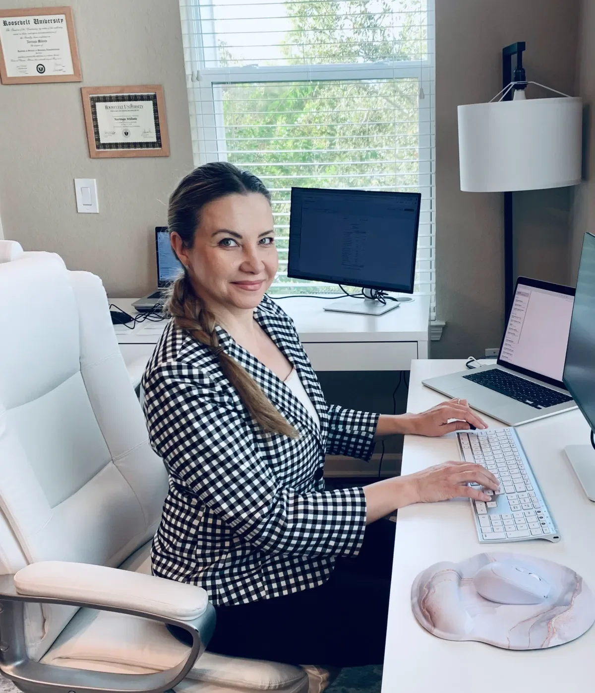 Bookkeeper Neri working on financial records at a desk