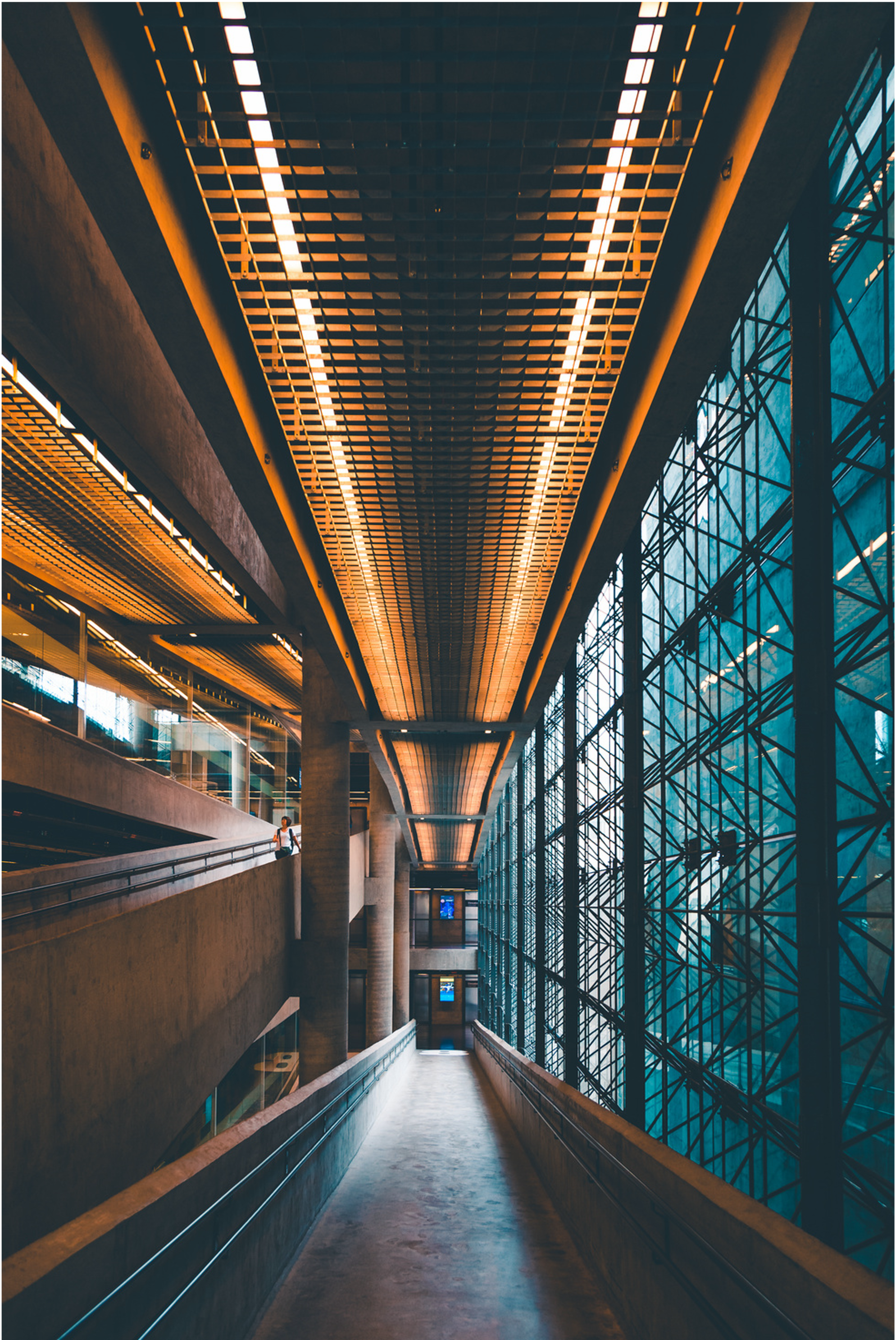 Office building corridor leading to an open space.