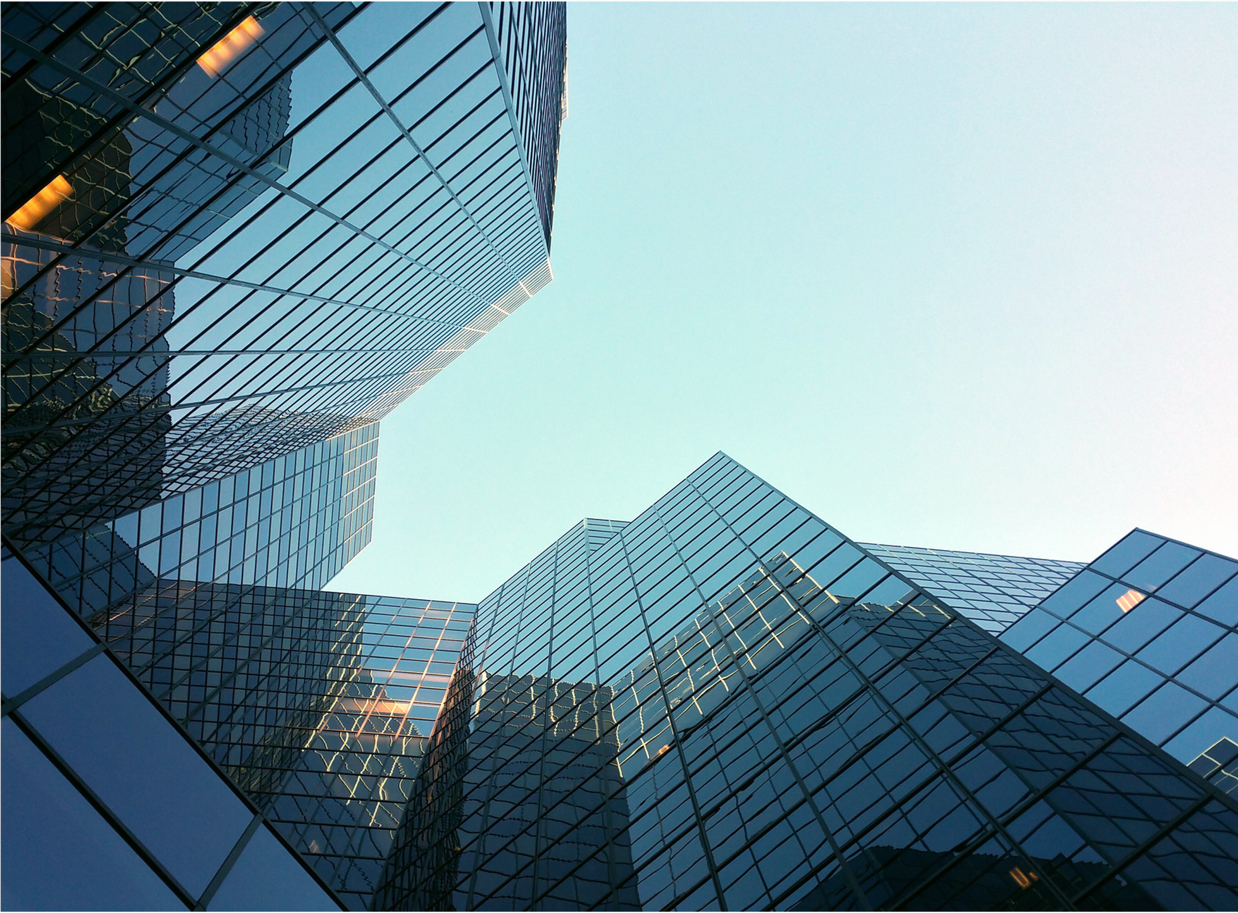Modern glass building extending towards the sky