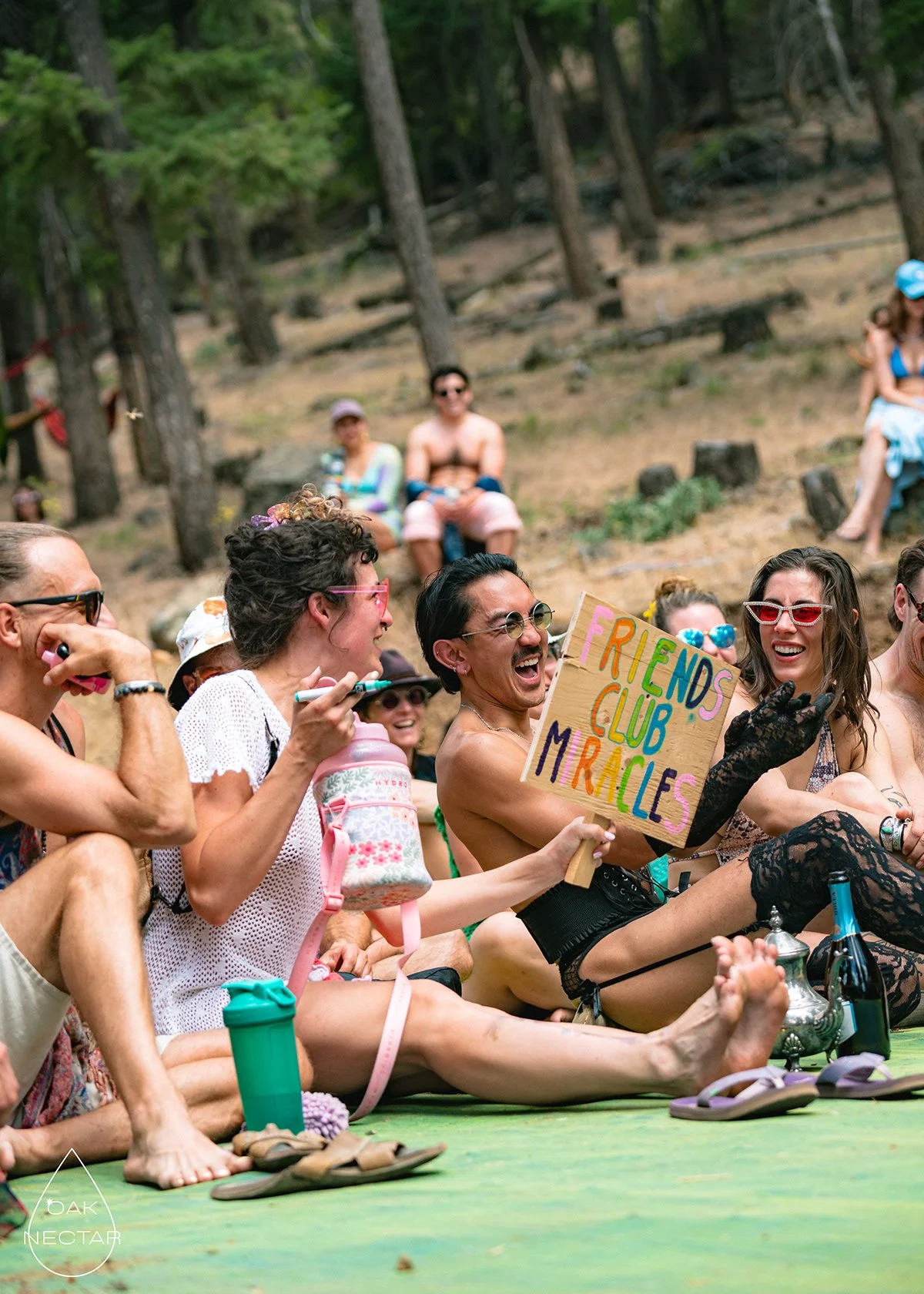 Friends at Friends Club holding a handmade sign