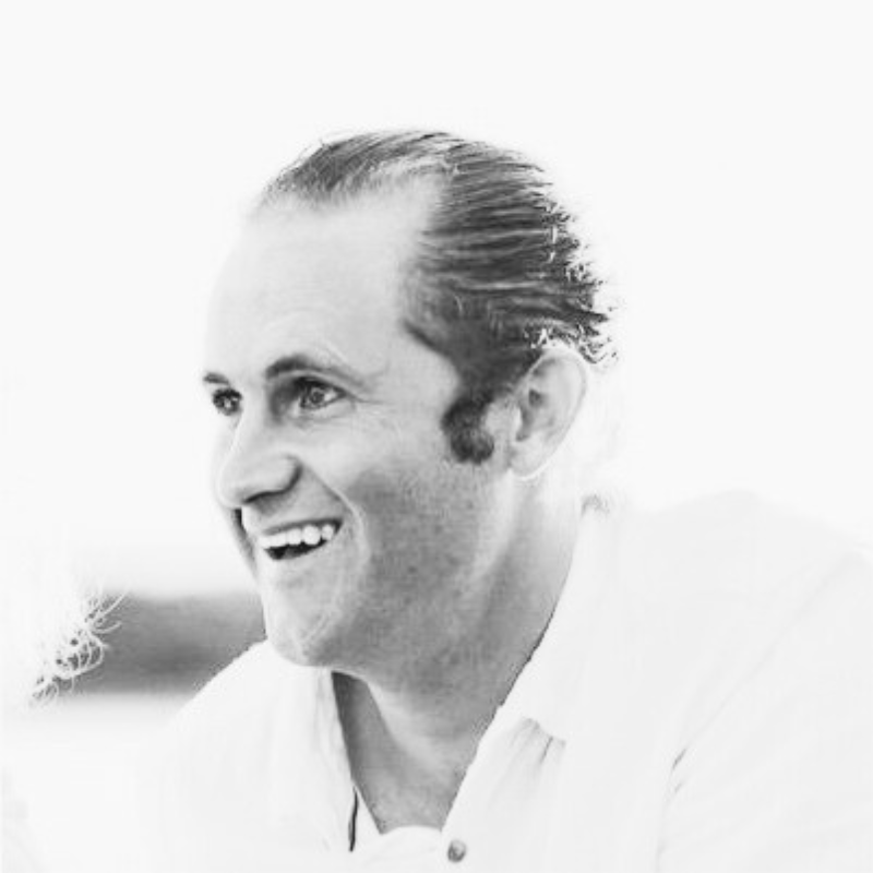 Black and white photo of a smiling person, side profile view