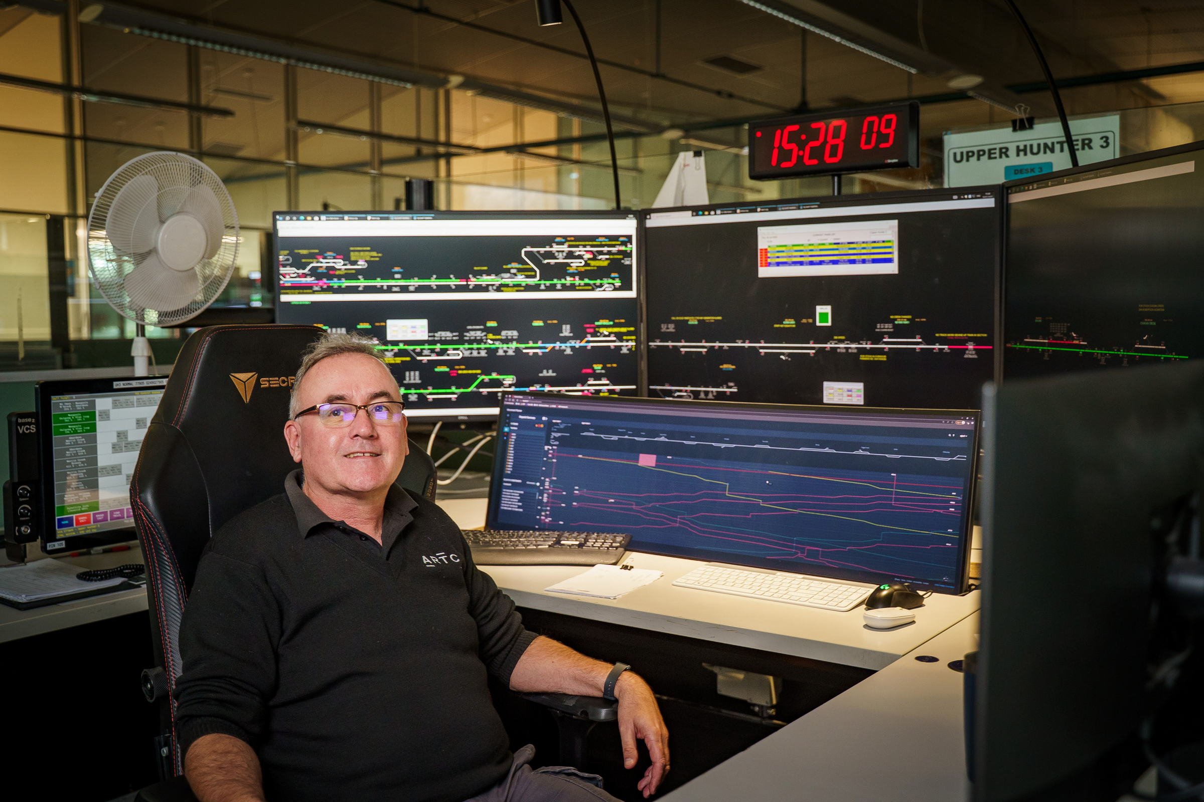 ARTC control room operator photographed at work in a rail network operations environment.