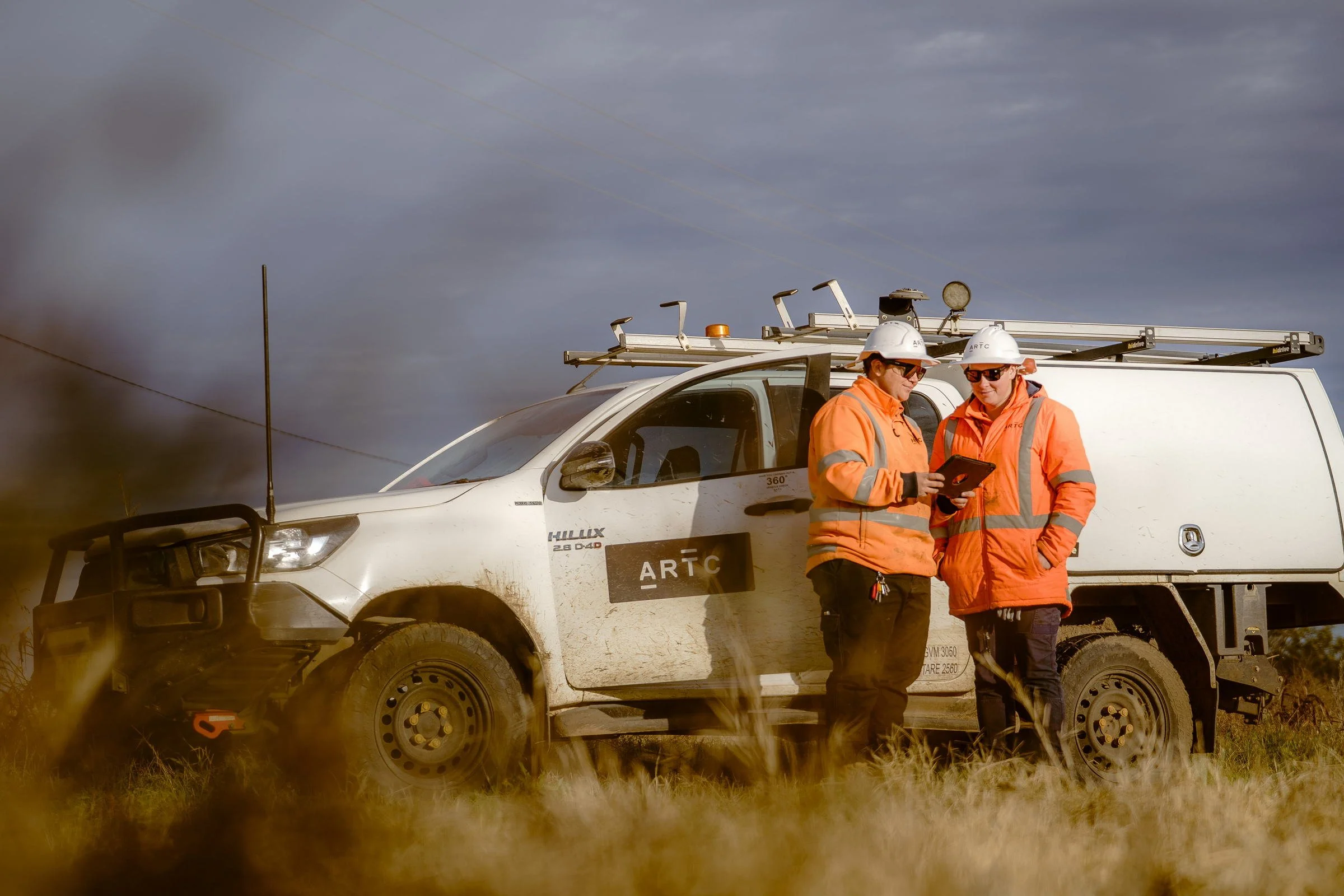 ARTC rail crew photographed beside a hi-rail maintenance vehicle during infrastructure work in Gunnedah.