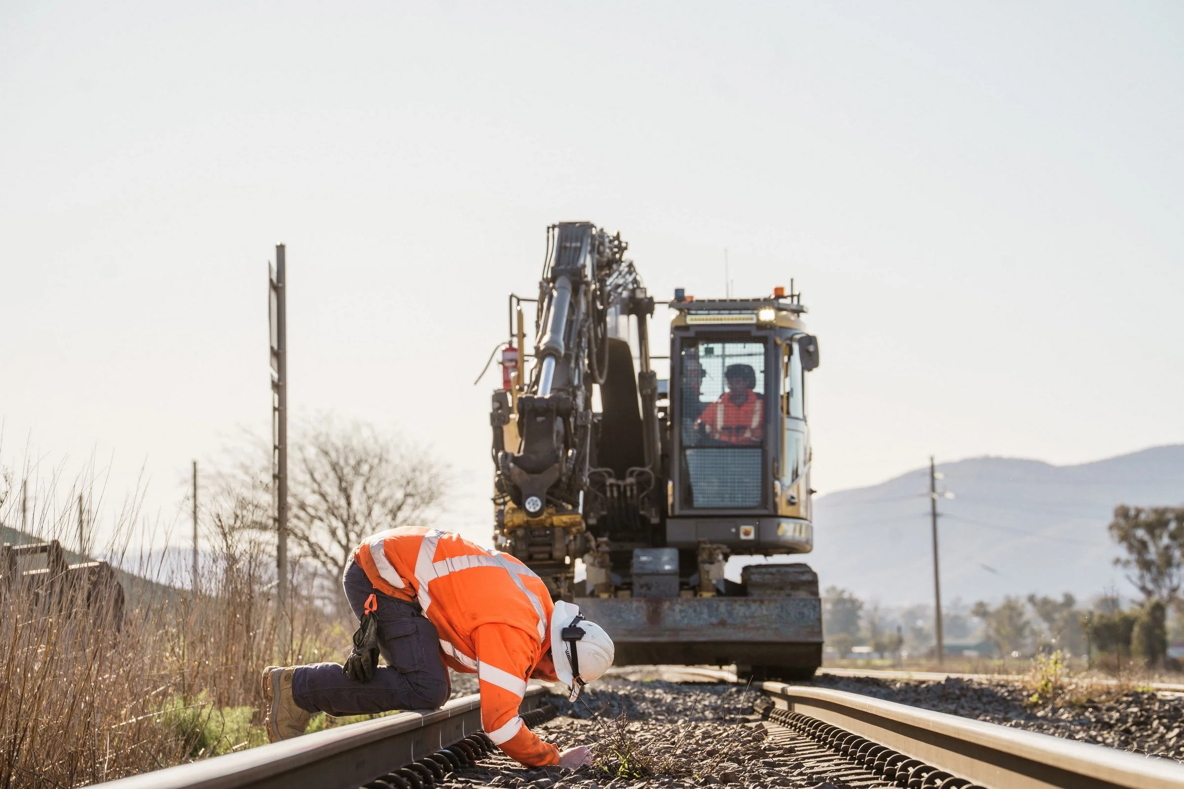 Rail excavator and worker photographed during ARTC trackwork operations in the Newcastle region.