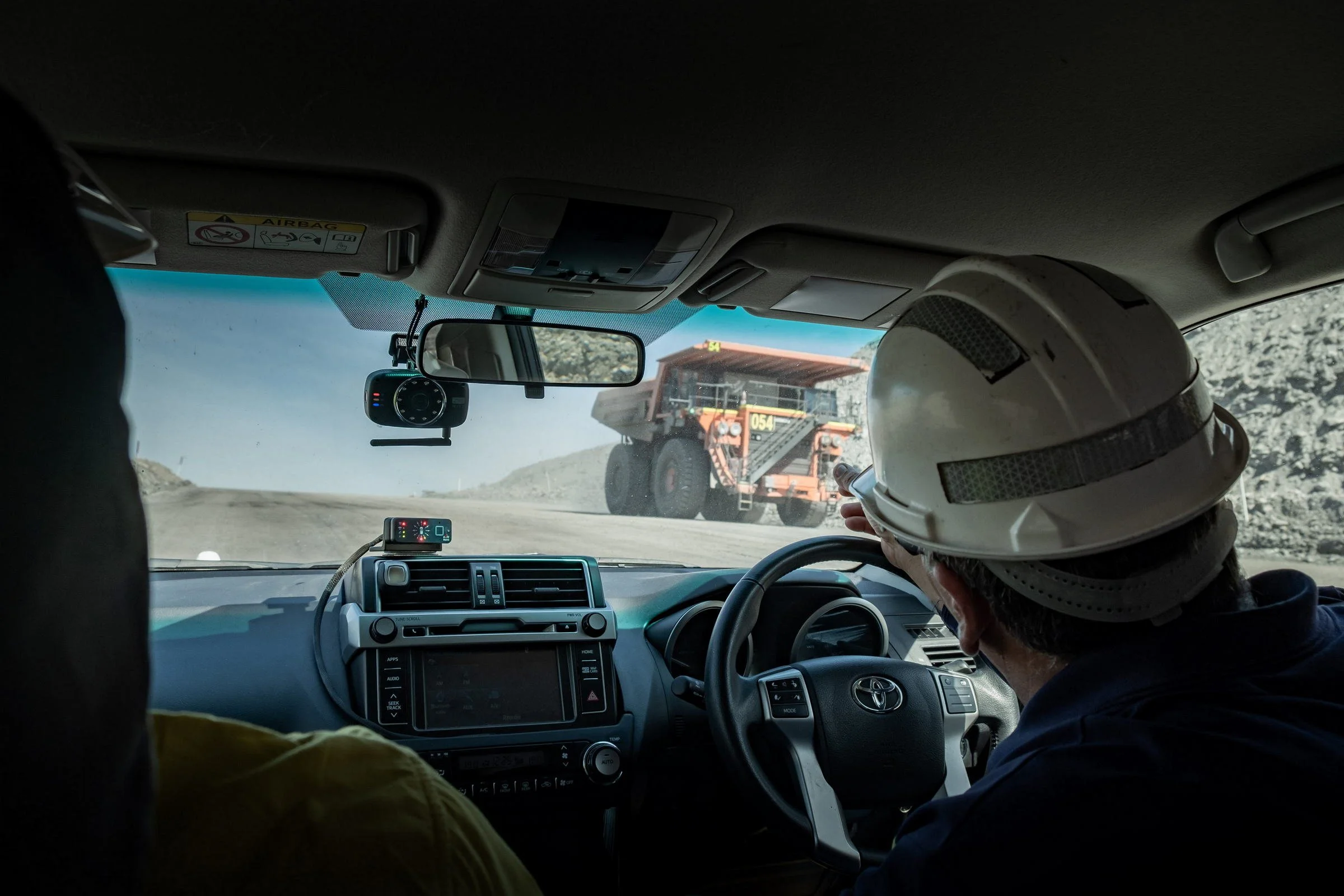 View from inside a mine vehicle cab during an open-cut mining site inspection in NSW.