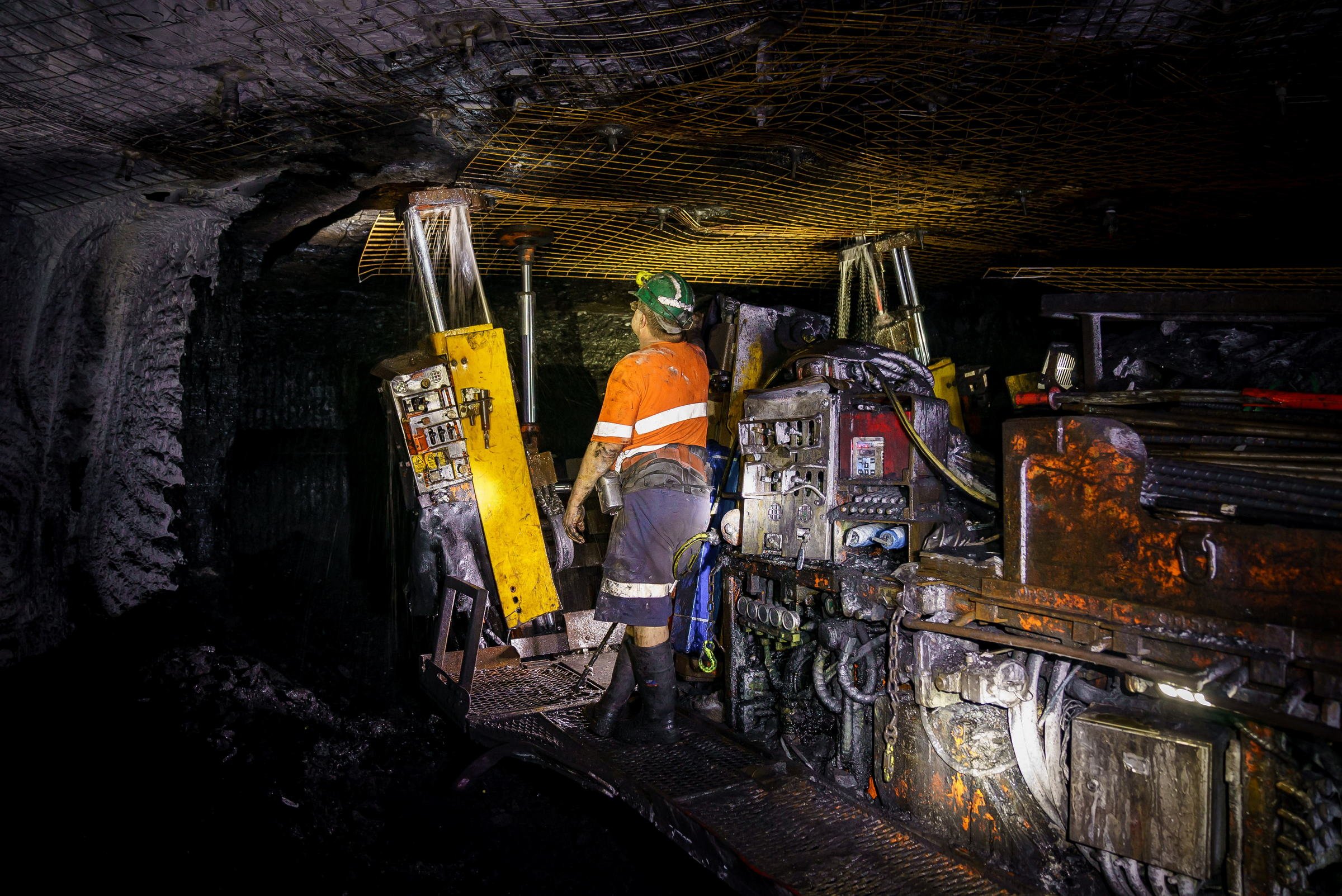 Underground mining crew working around machinery at Myuna Mine in NSW.