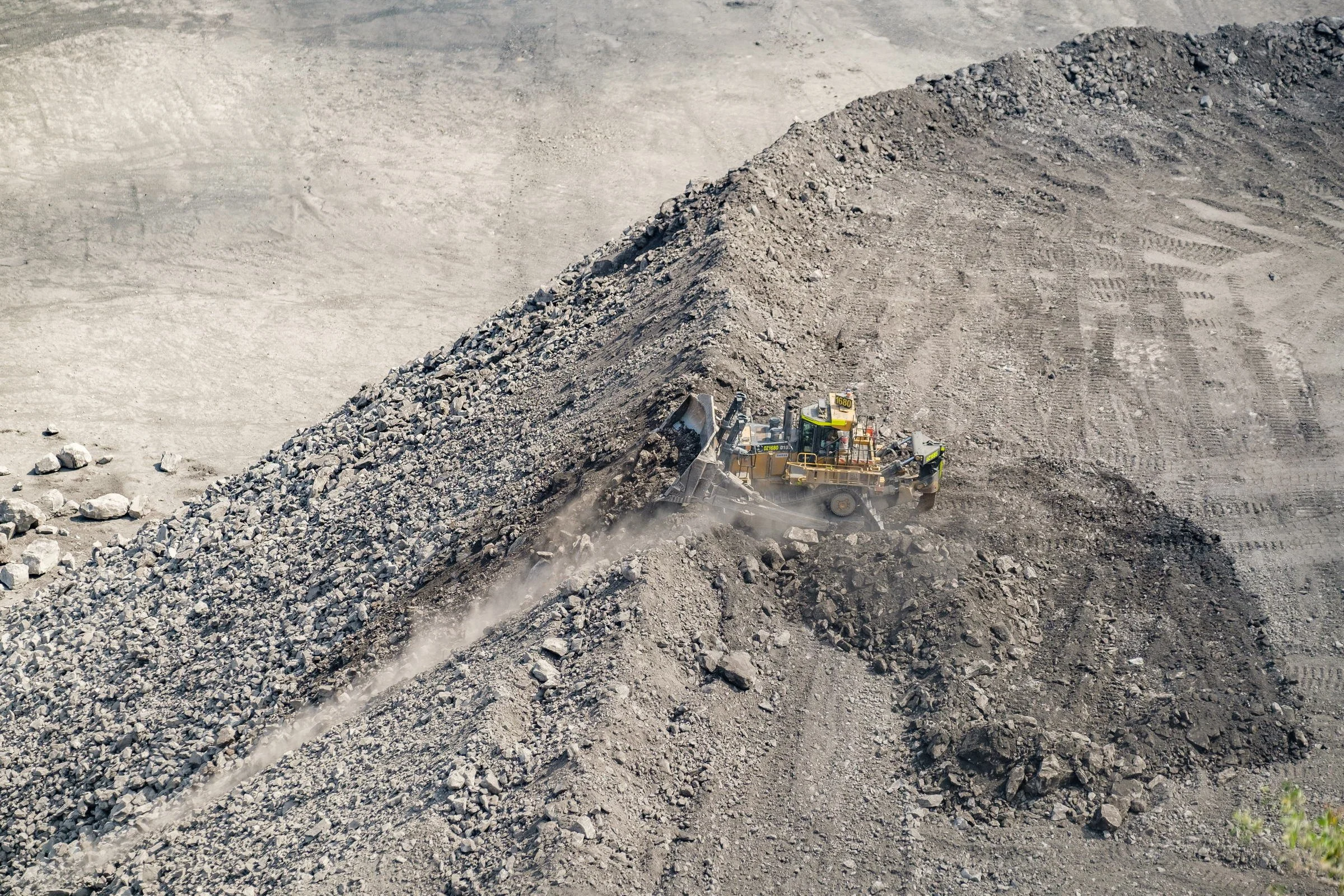 Excavator working on overburden and spoil at an open-cut mine site in NSW.