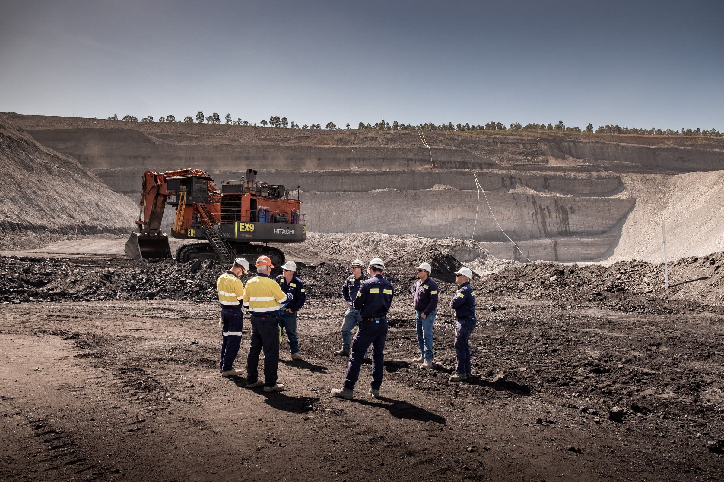 Mining inspection team overlooking an open-cut mine pit during a regulatory image library shoot in NSW.