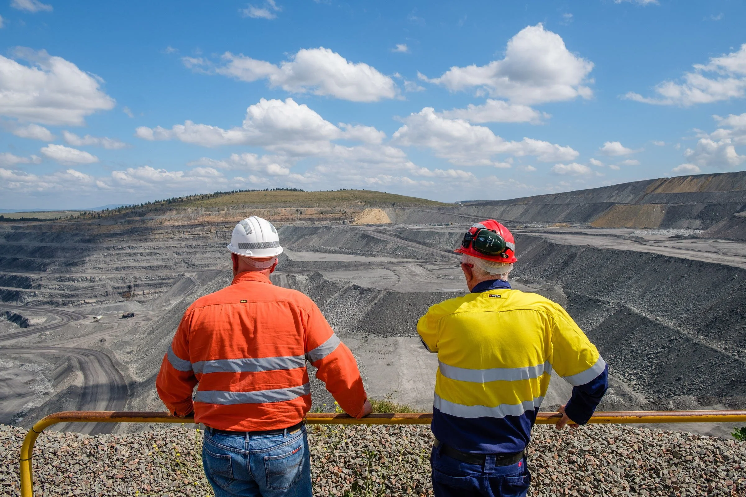 Mining personnel looking over an open-cut mine landscape during a site inspection in NSW.