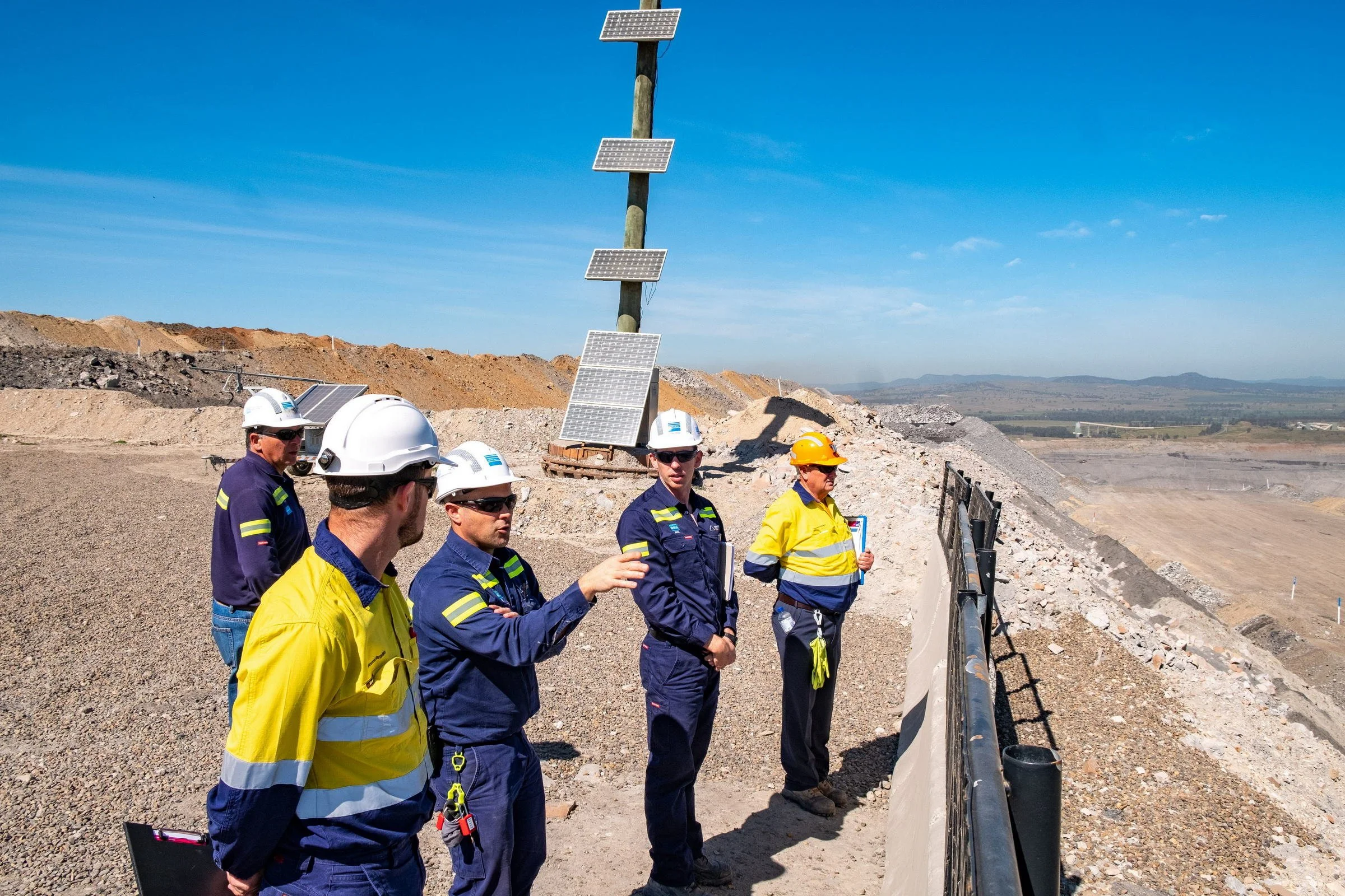NSW Resources Regulator inspectors reviewing an open-cut mine site from an elevated inspection point in NSW.