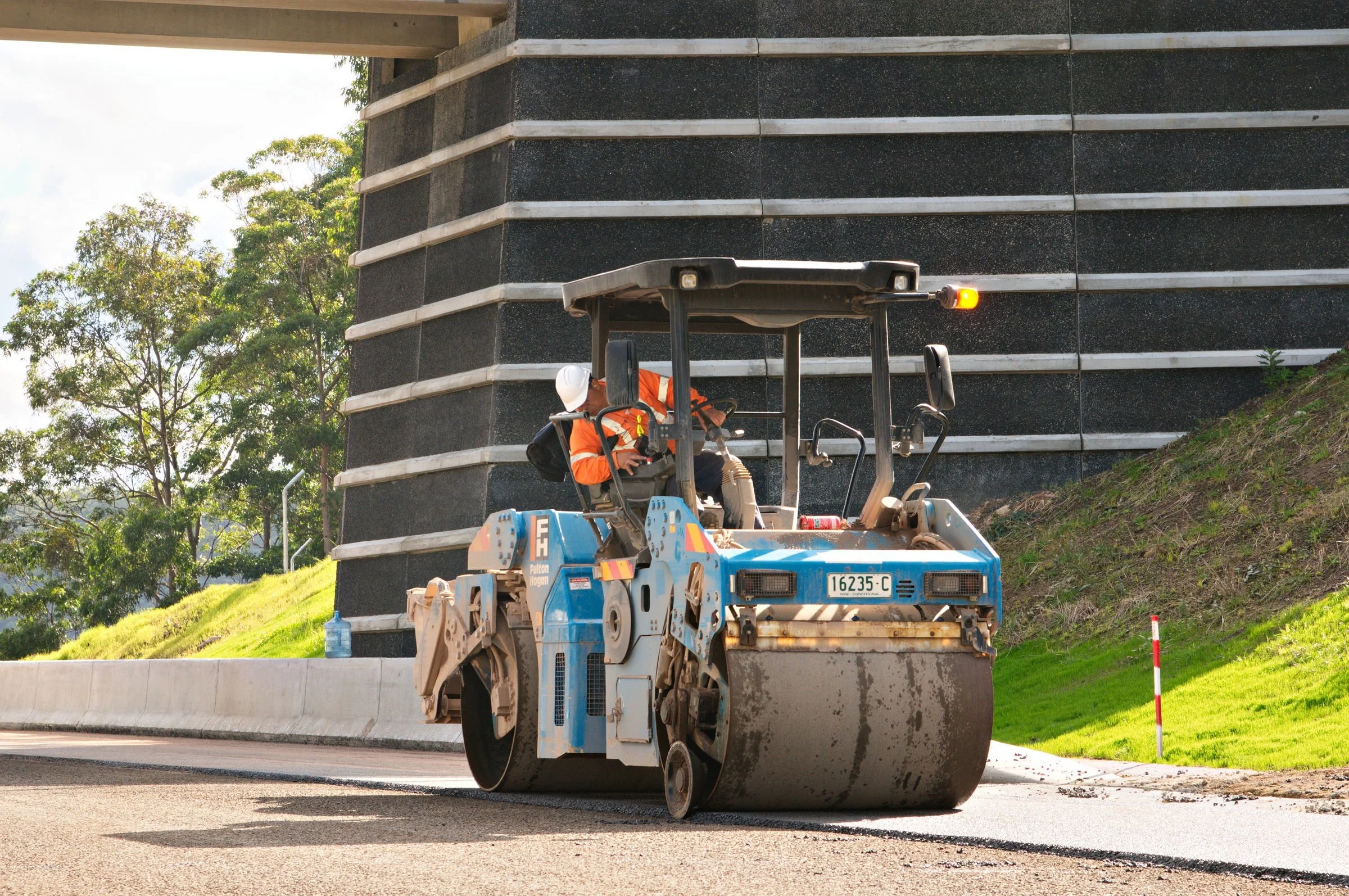 Road roller compacting asphalt on the Hunter Expressway