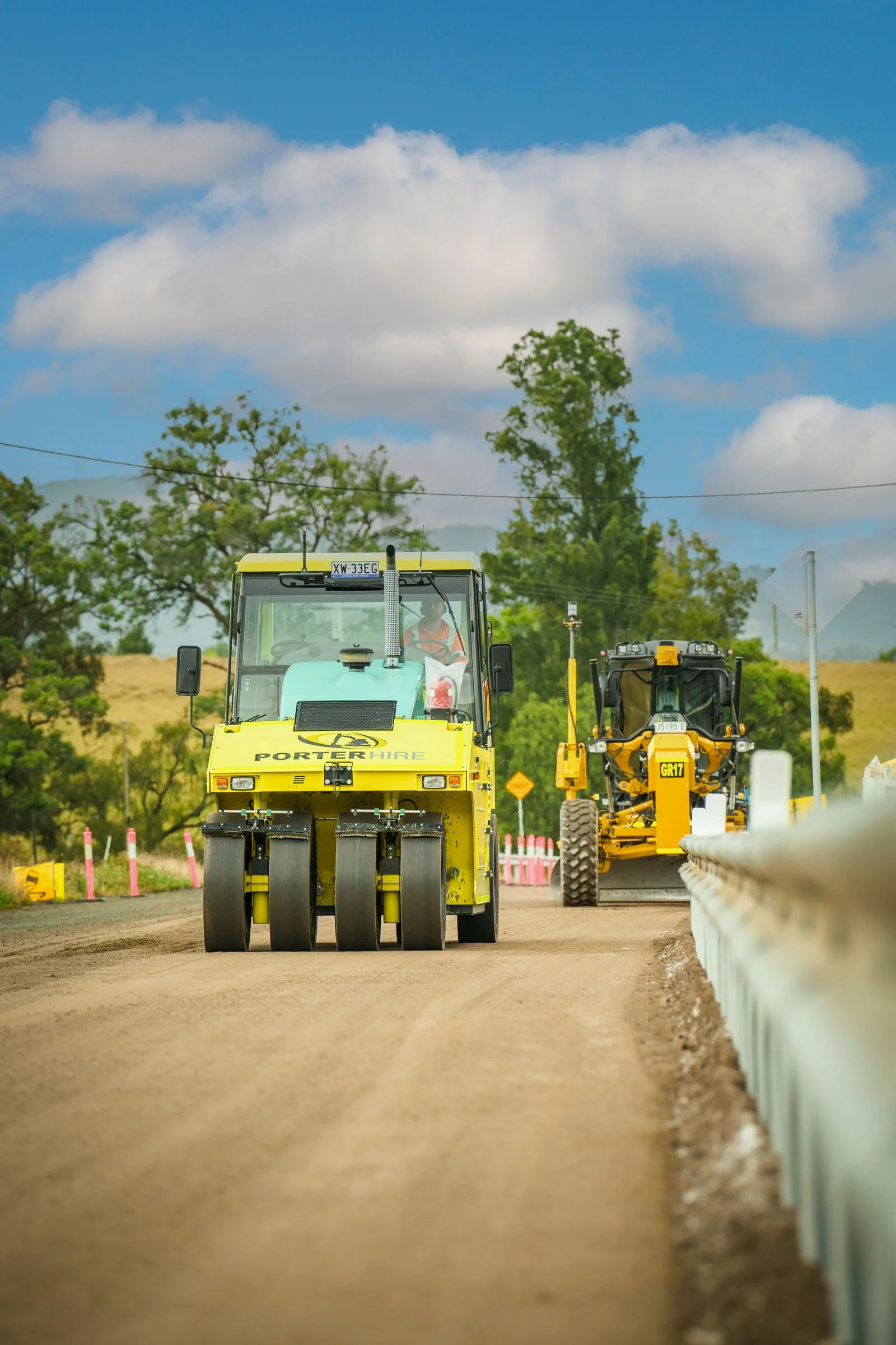 Ammann roller working along a newly prepared road construction surface