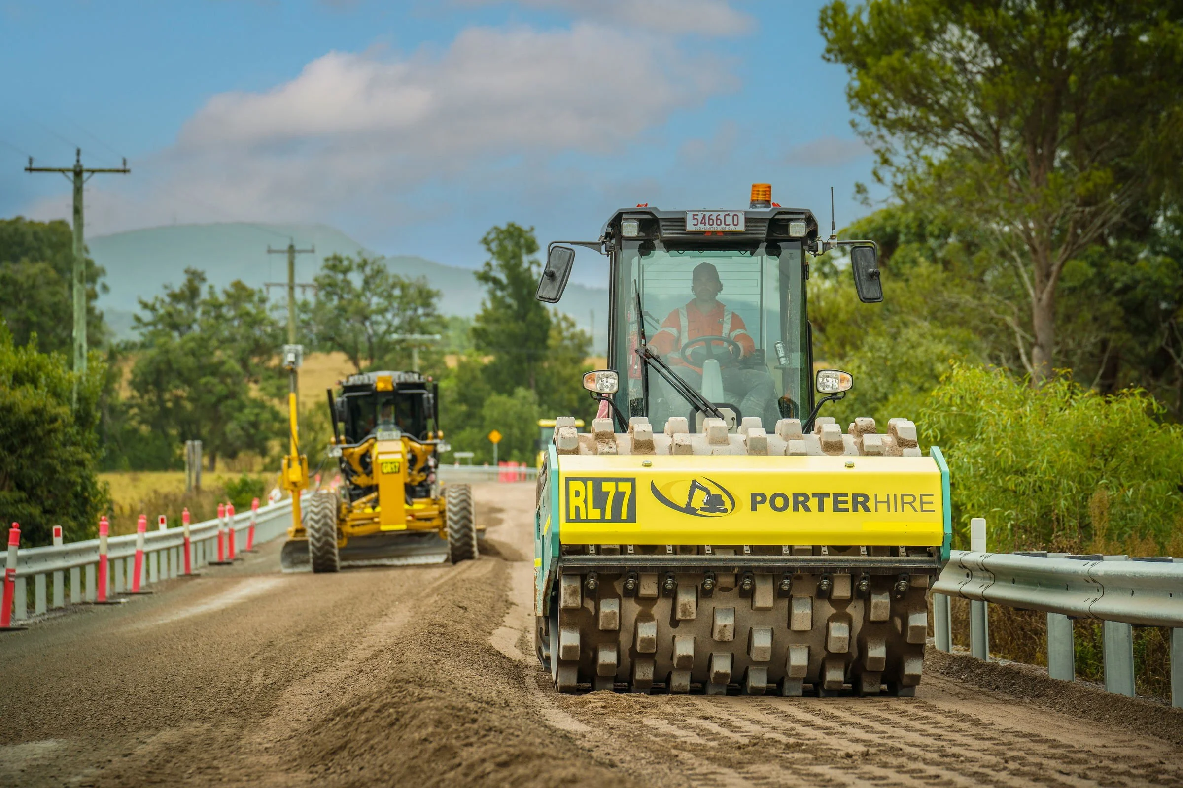 Porter Hire road roller operating with construction plant on site