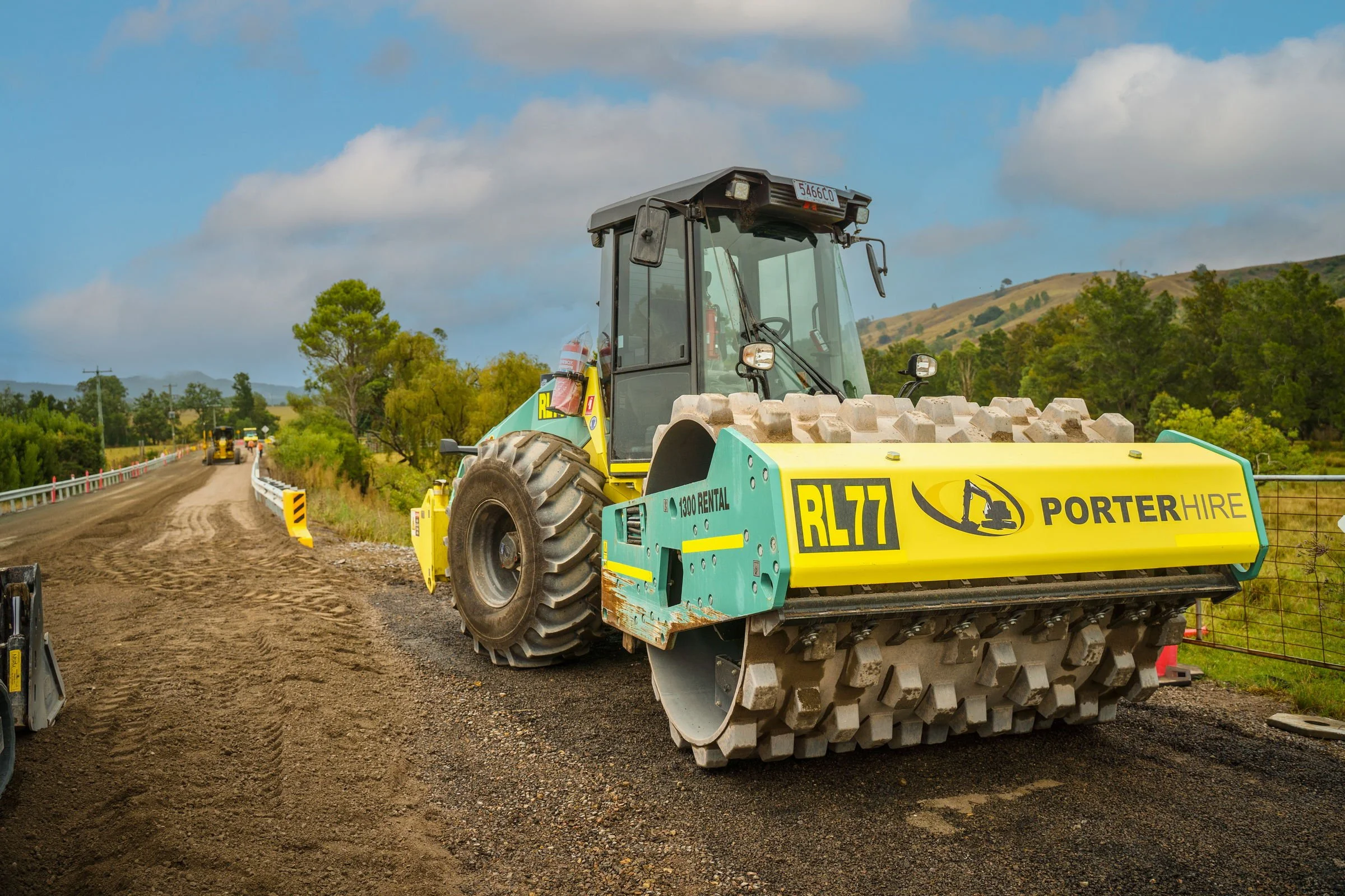 Ammann roller working along a newly prepared road construction surface