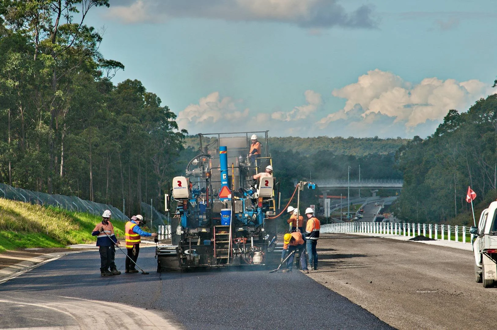 Road paving crew working on the Hunter Expressway construction project in the Hunter region NSW
