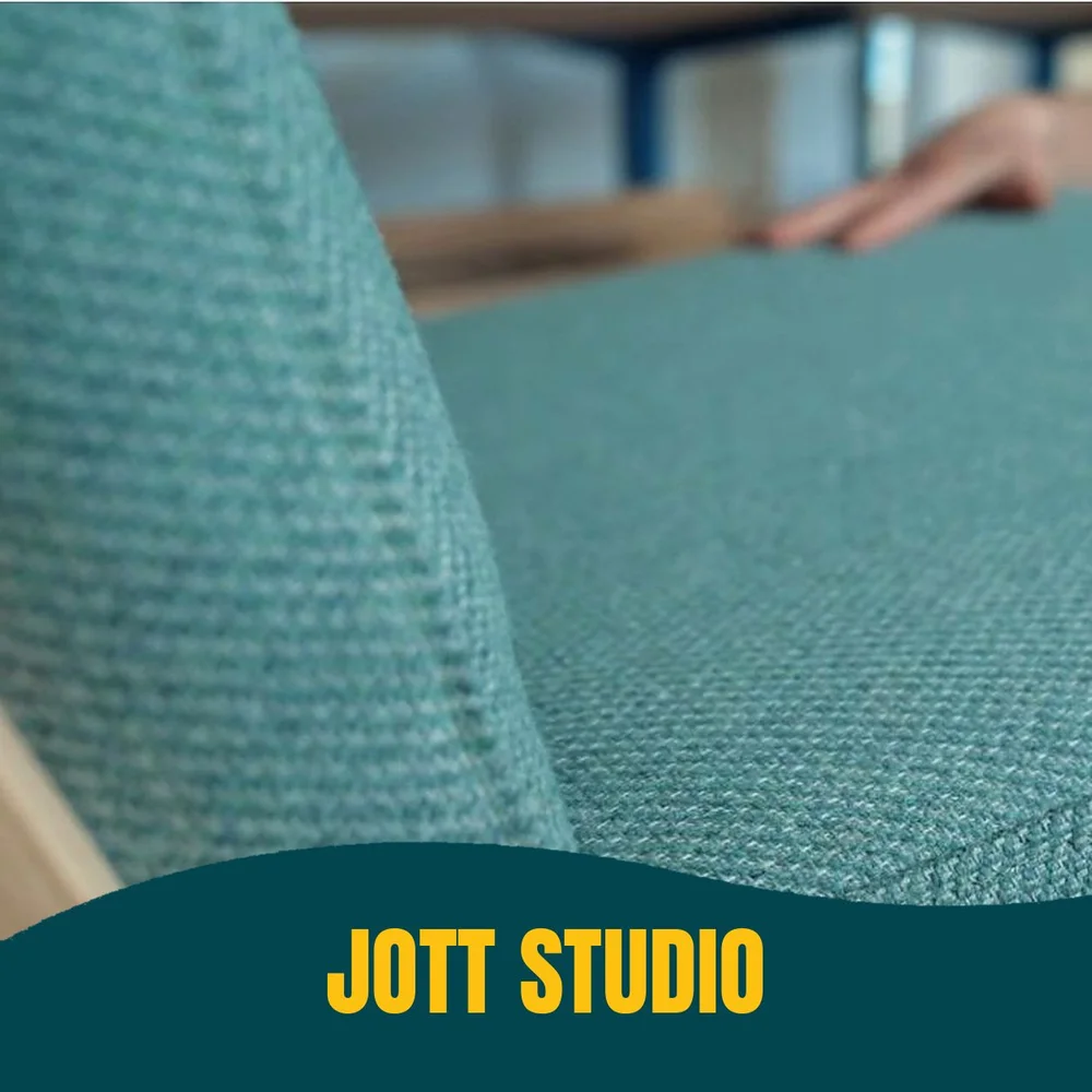 A teal upholstered chair being finished in Jott Studio’s workshop, filmed by Jooka