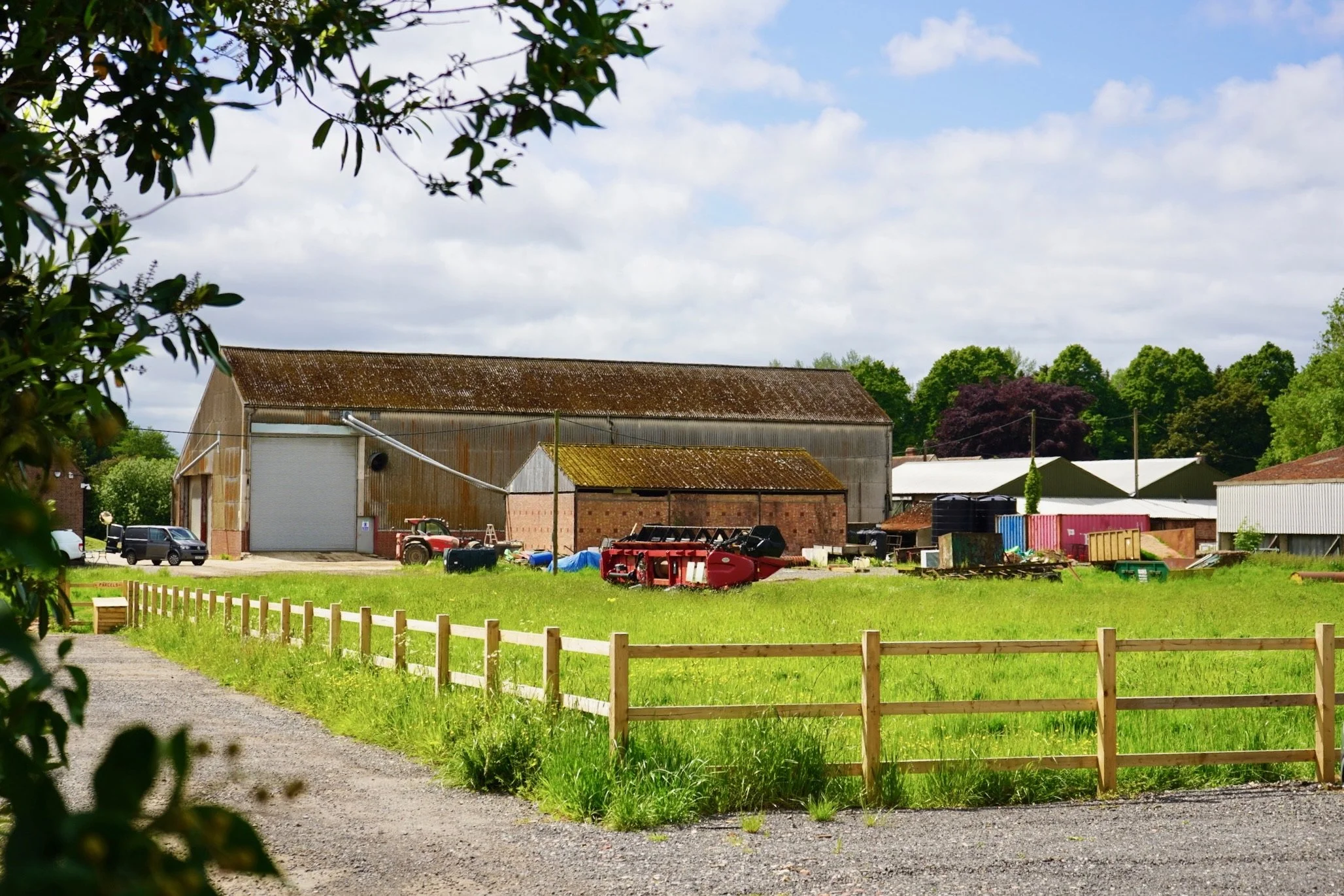 Rural farm with barn, tractor, and green field