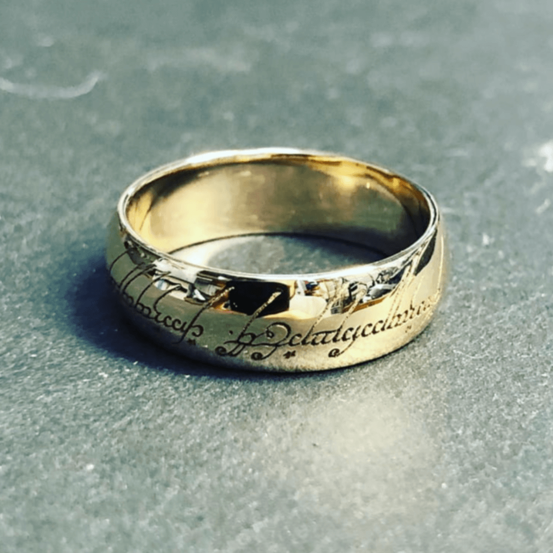 A silver ring from the film The Hobbit, with the inscription ''One ring to rule them all" in Elvish engraved around the outside.