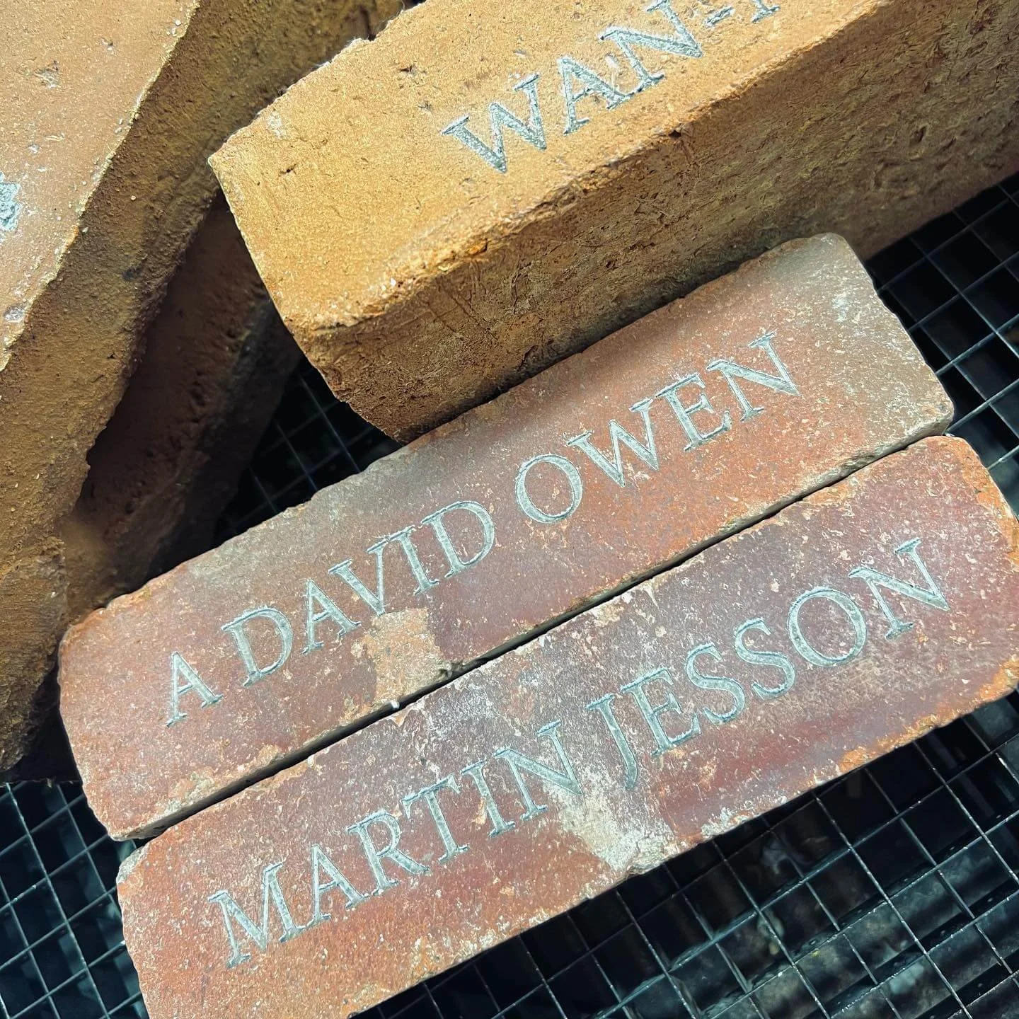 Three engraved bricks with names, reading from top to bottom: 'WALKER', 'A DAVID OWEN', and 'MARTIN JESSON'.