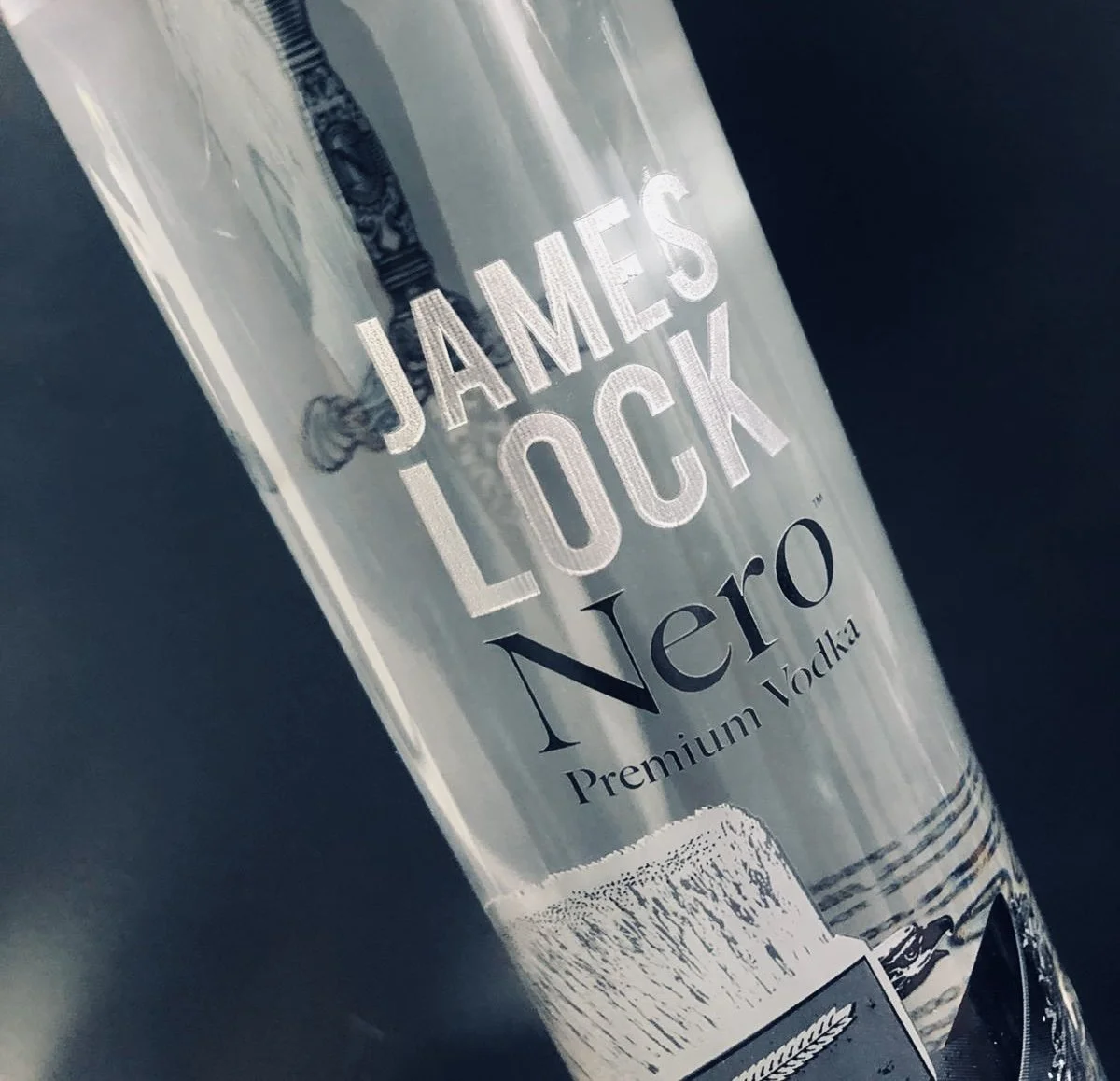 Nero vodka bottles engraved and hand infilled with silver carnauba wax.