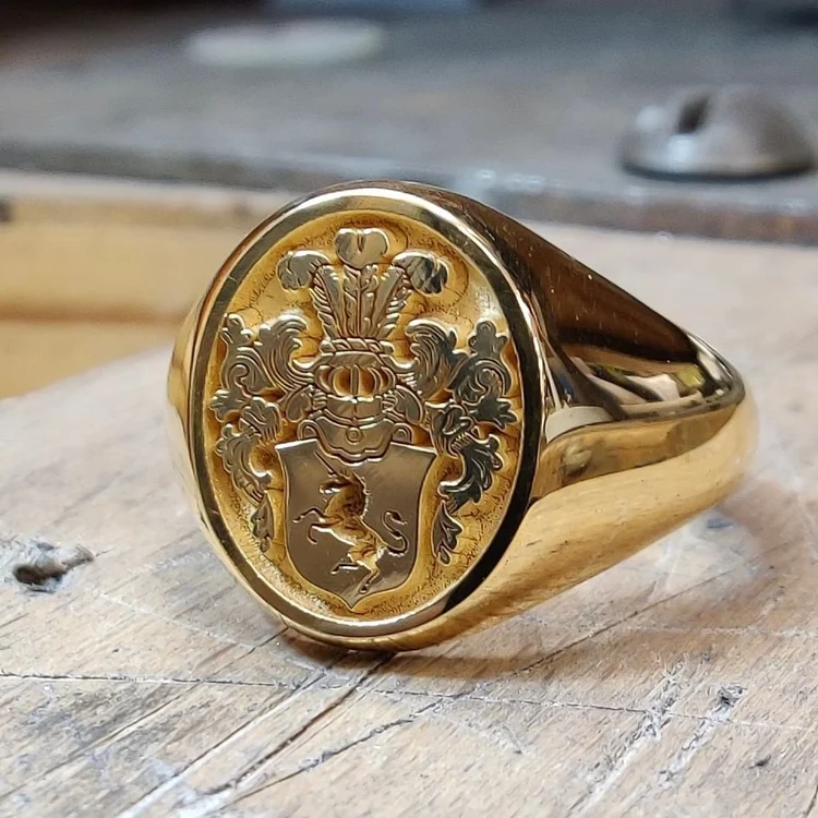 Recycled gold signet ring engraved with a full coat of arms including shield, mantle and motto