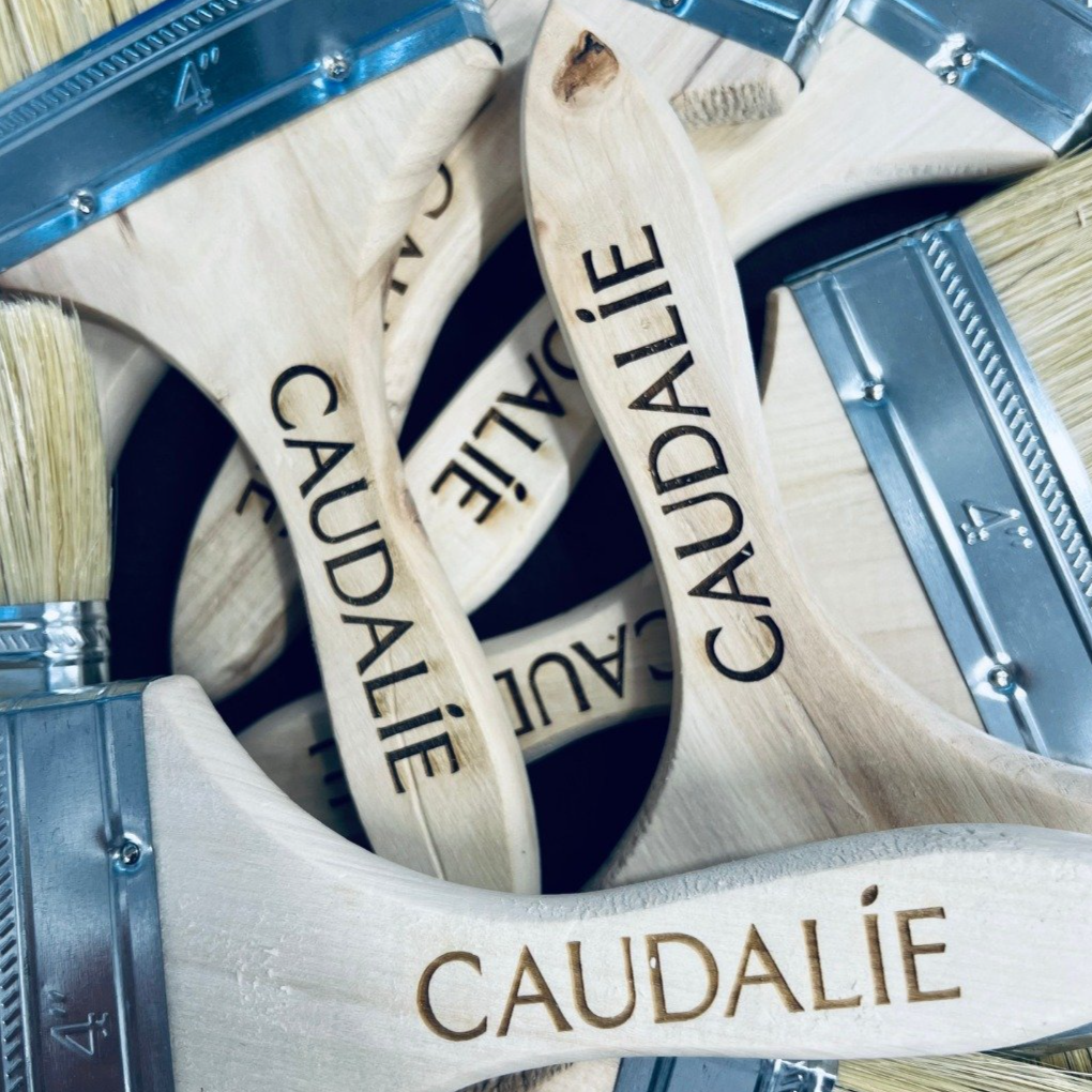Collection of wooden paint spatulas engraved with ''Caudalie"