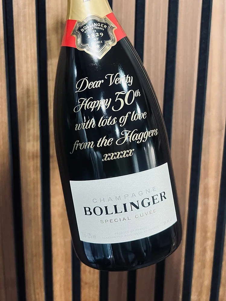 Engraved champagne bottle hand infilled with gold wax.