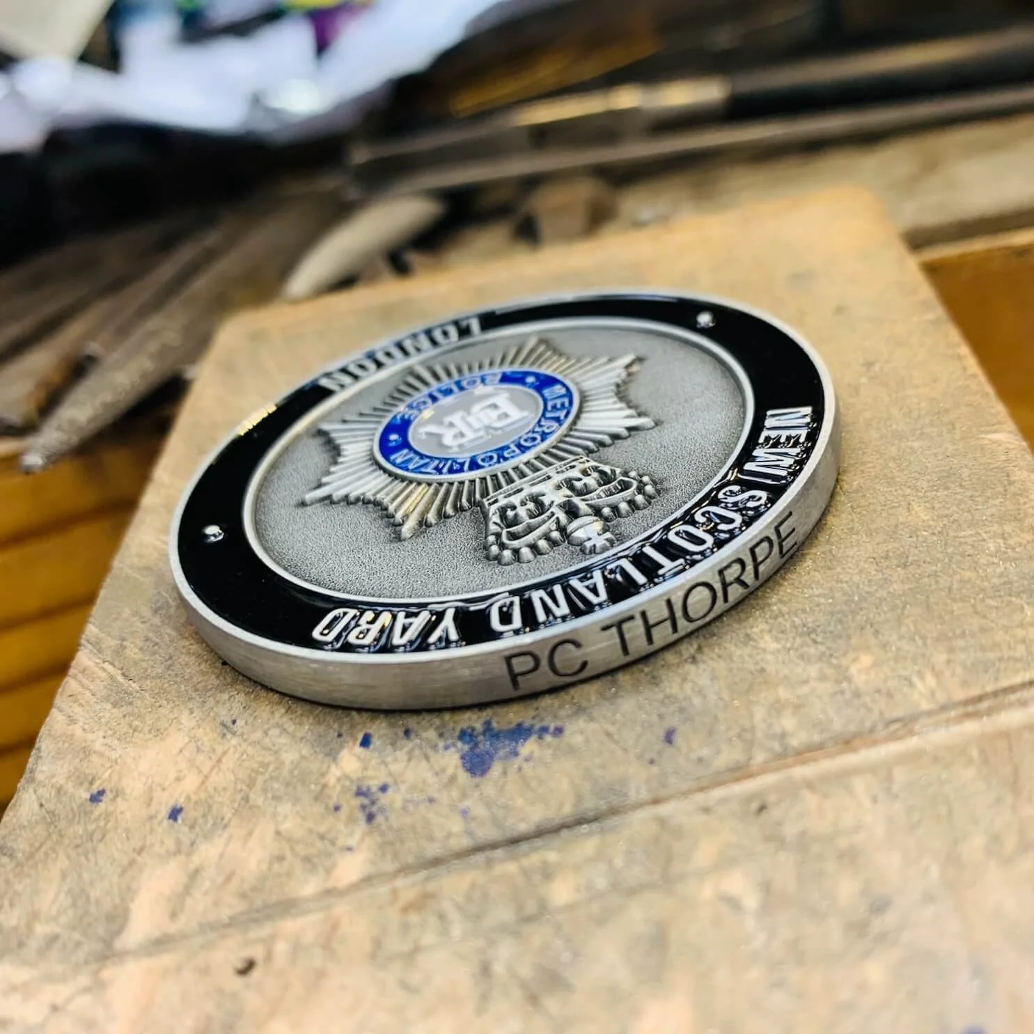 Close-up police medal that has been engraved.