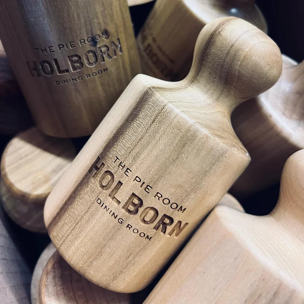 Wooden pie press engraved with 'The Pie Room Holborn Dining Room'.