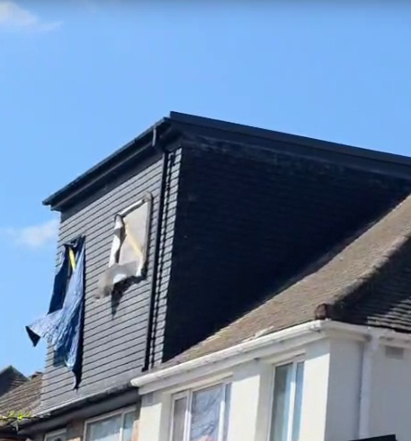Clothes hanging on a line outside a house.