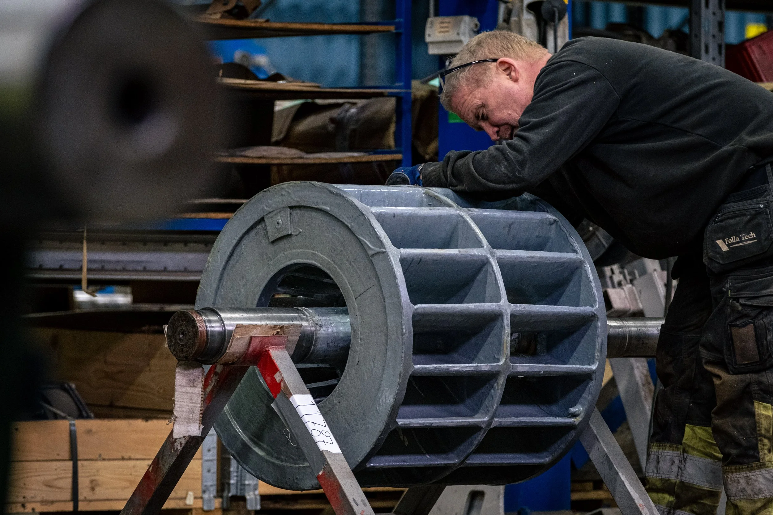 A man working on part of a vaccum pump.