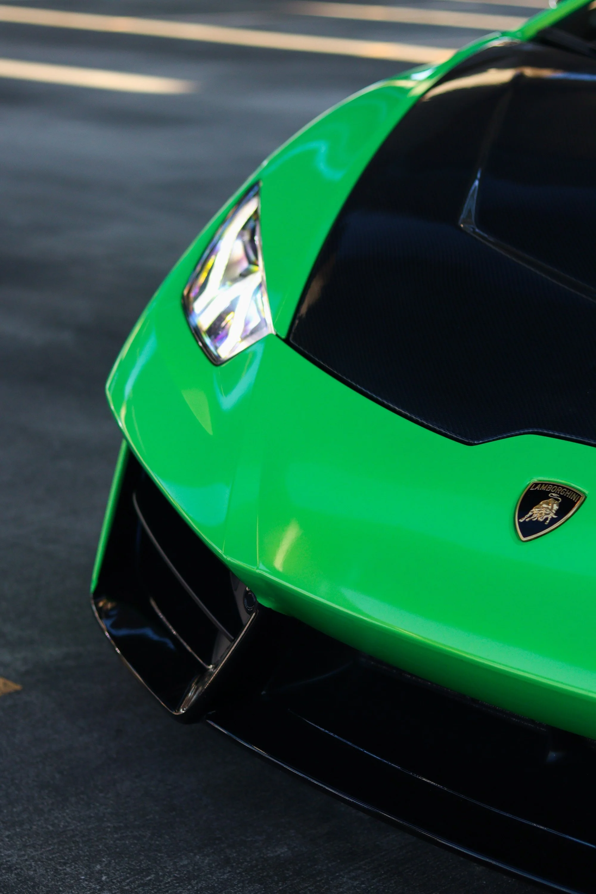 Lamborghini badge and front hood detail on green 2019 Huracan Spyder rental in Tampa.