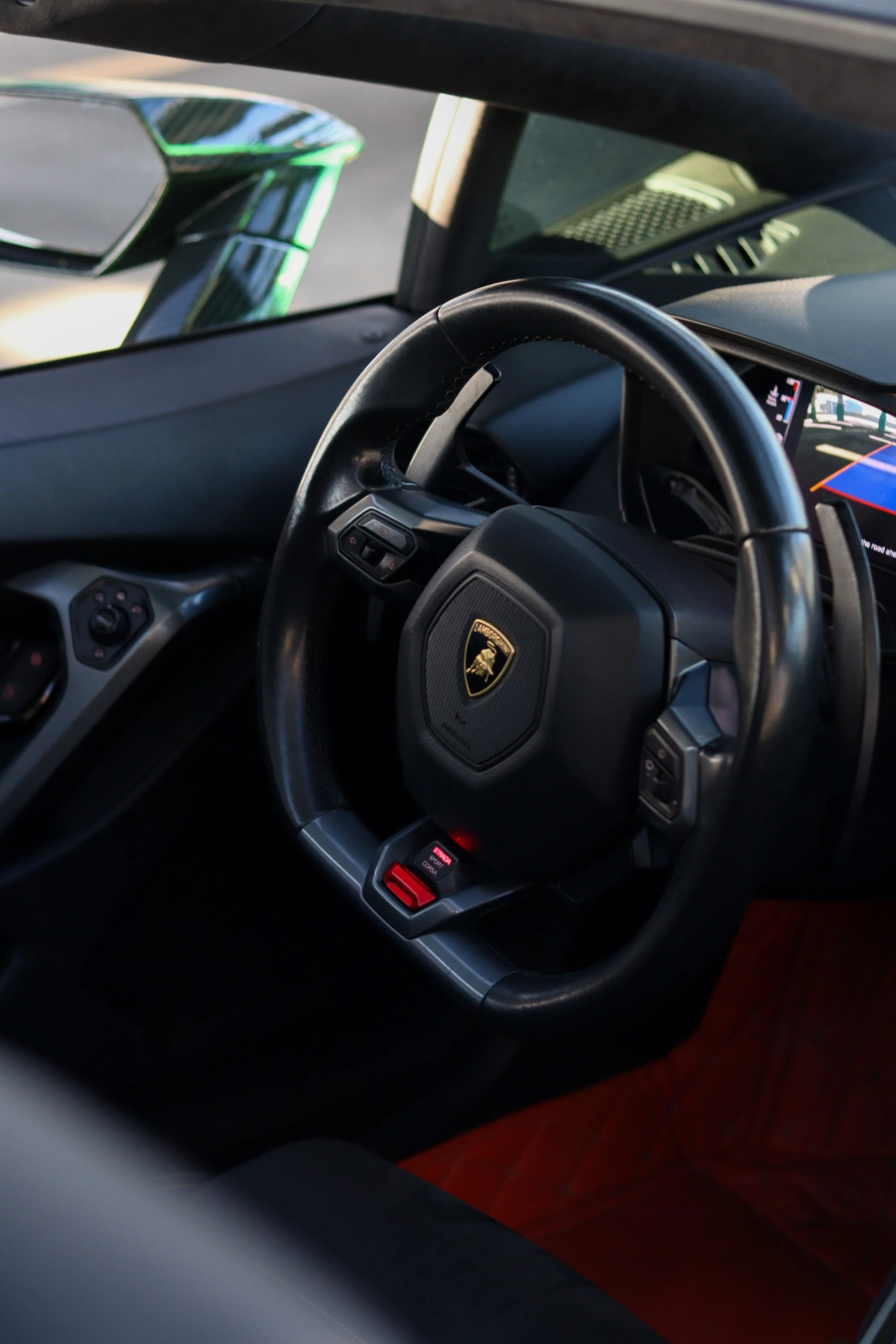Interior steering wheel and driver cockpit of 2019 Lamborghini Huracan Spyder rental in Tampa, Florida.