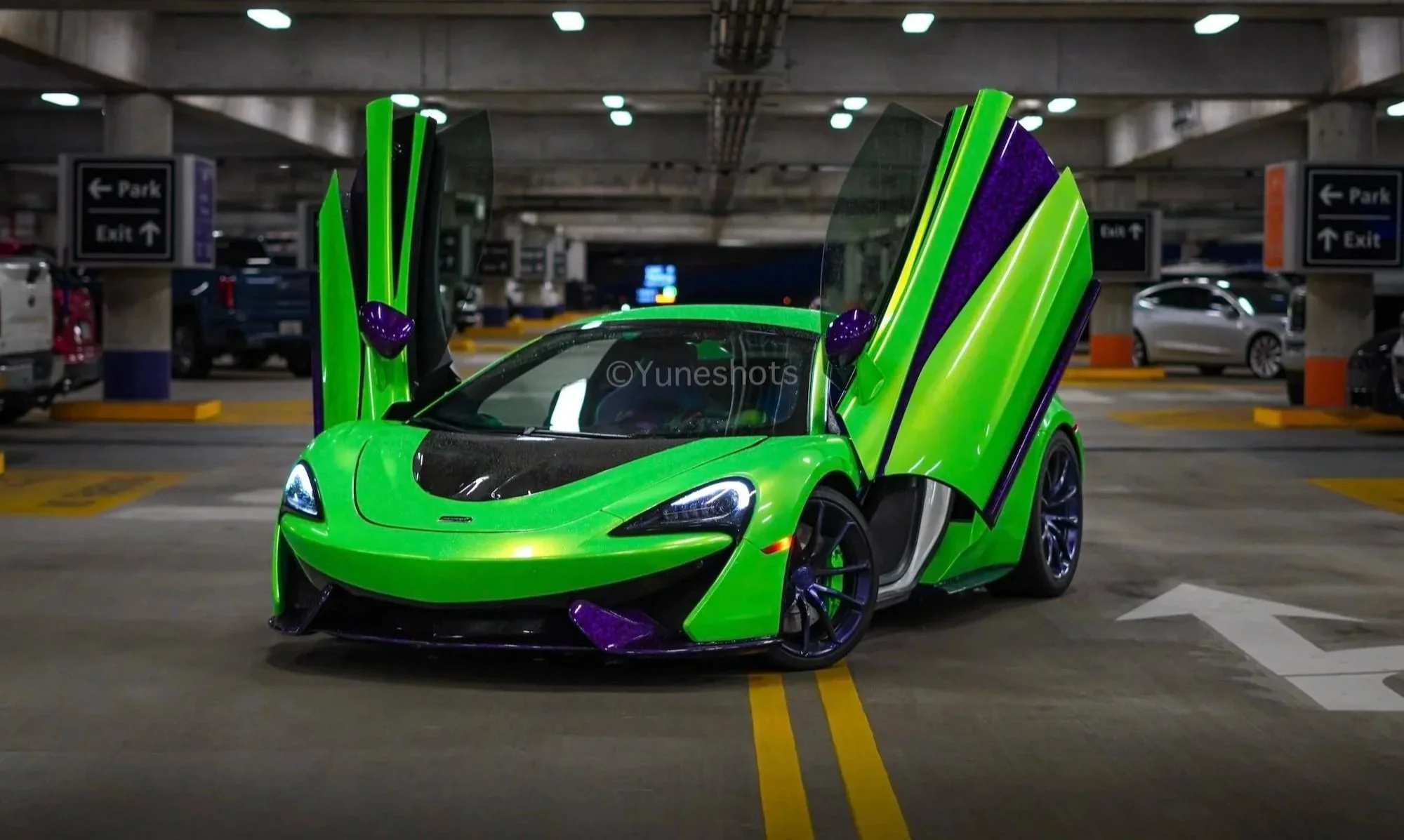 Custom green 2020 McLaren 570S Spyder with purple forged carbon fiber accents and dihedral doors open, available for exotic car rental in Tampa, Clearwater, St. Petersburg, Sarasota, and Miami, Florida.