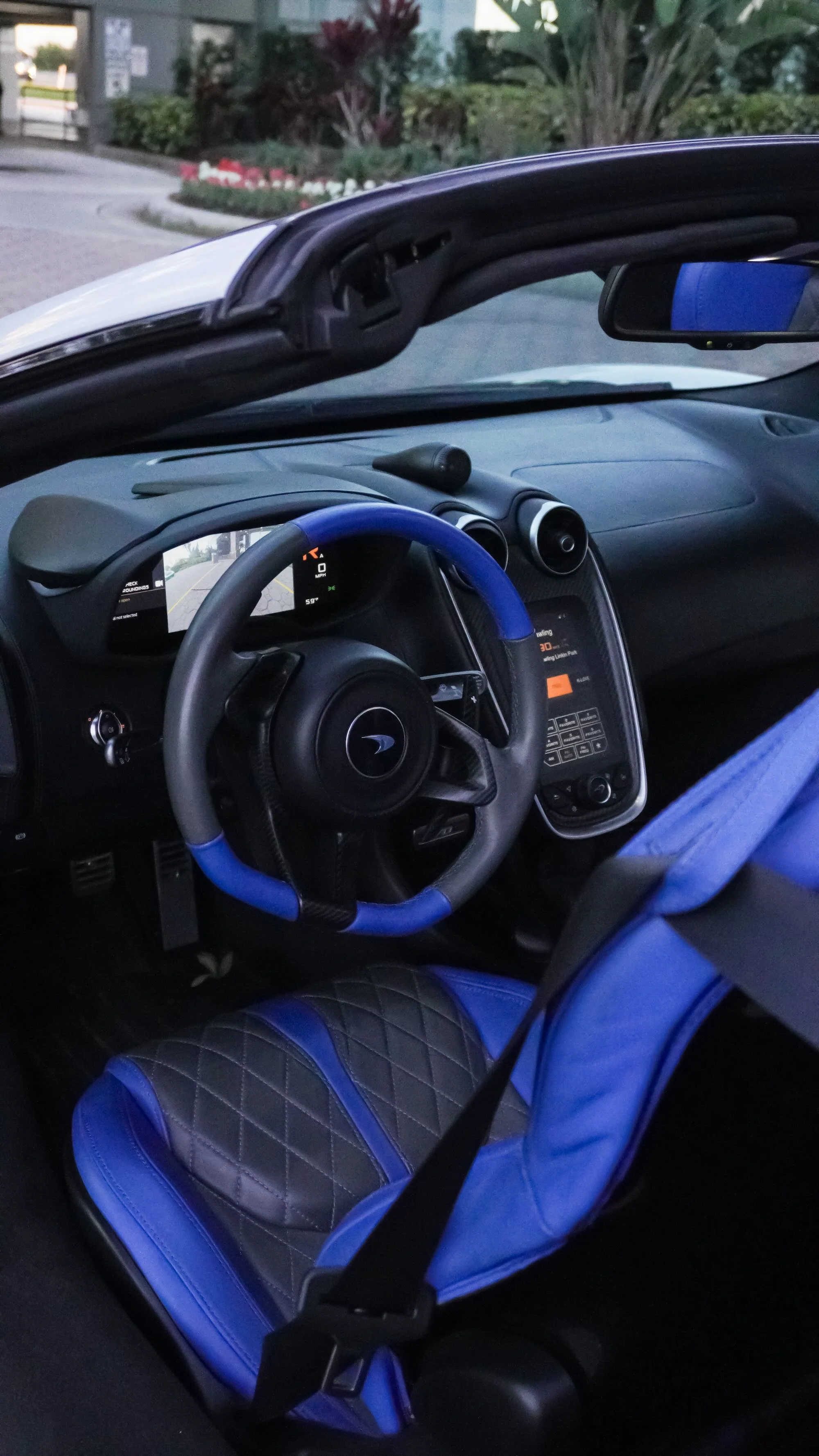 McLaren 570S Spyder interior with blue accents and steering wheel view