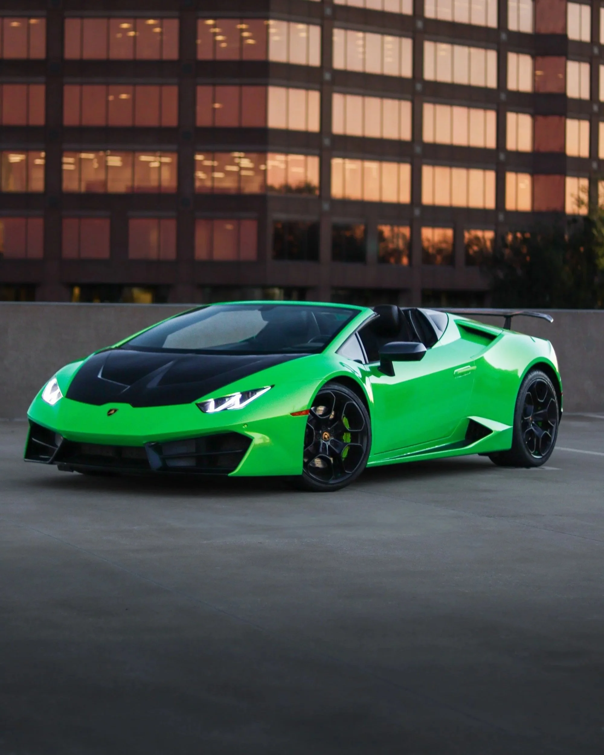 Green Lamborghini Huracan Spyder rental in Tampa, Florida with black wheels and aggressive front fascia, available for exotic car rental through SteerForce Rentals.